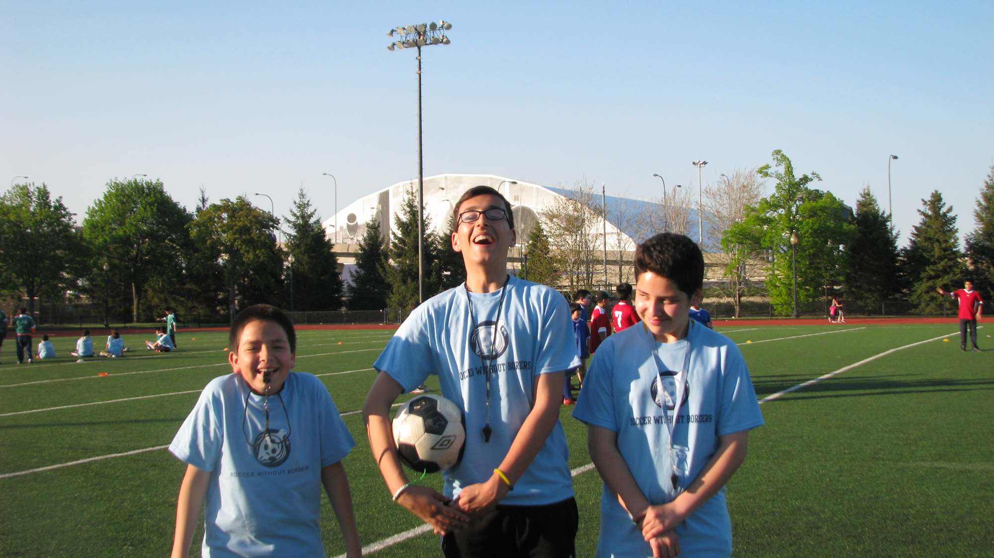 a group of people posing for the camera on a football field