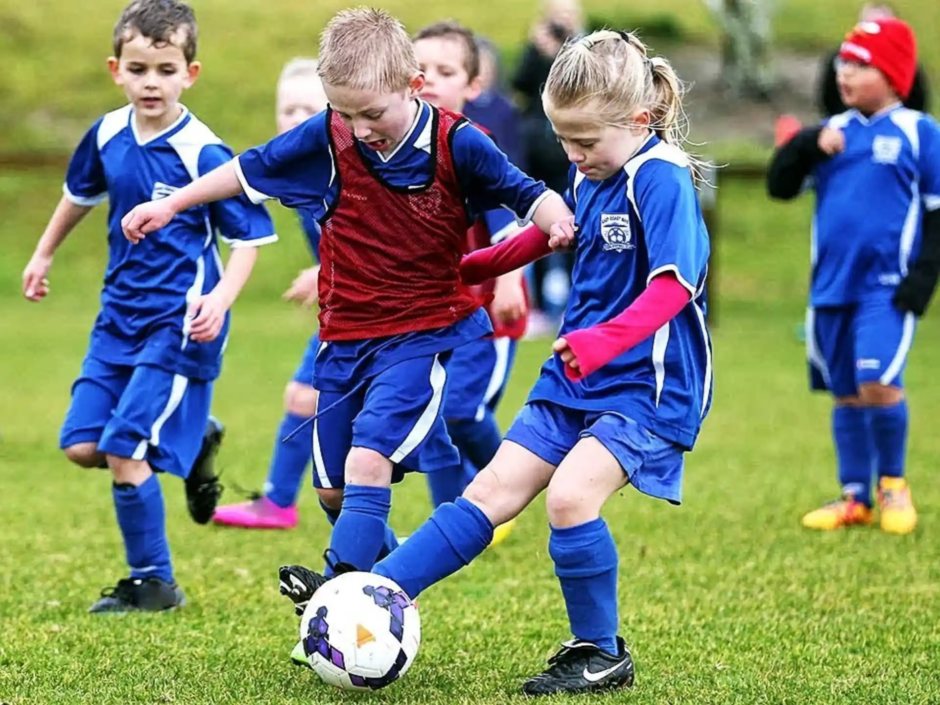 kids playing football on a field