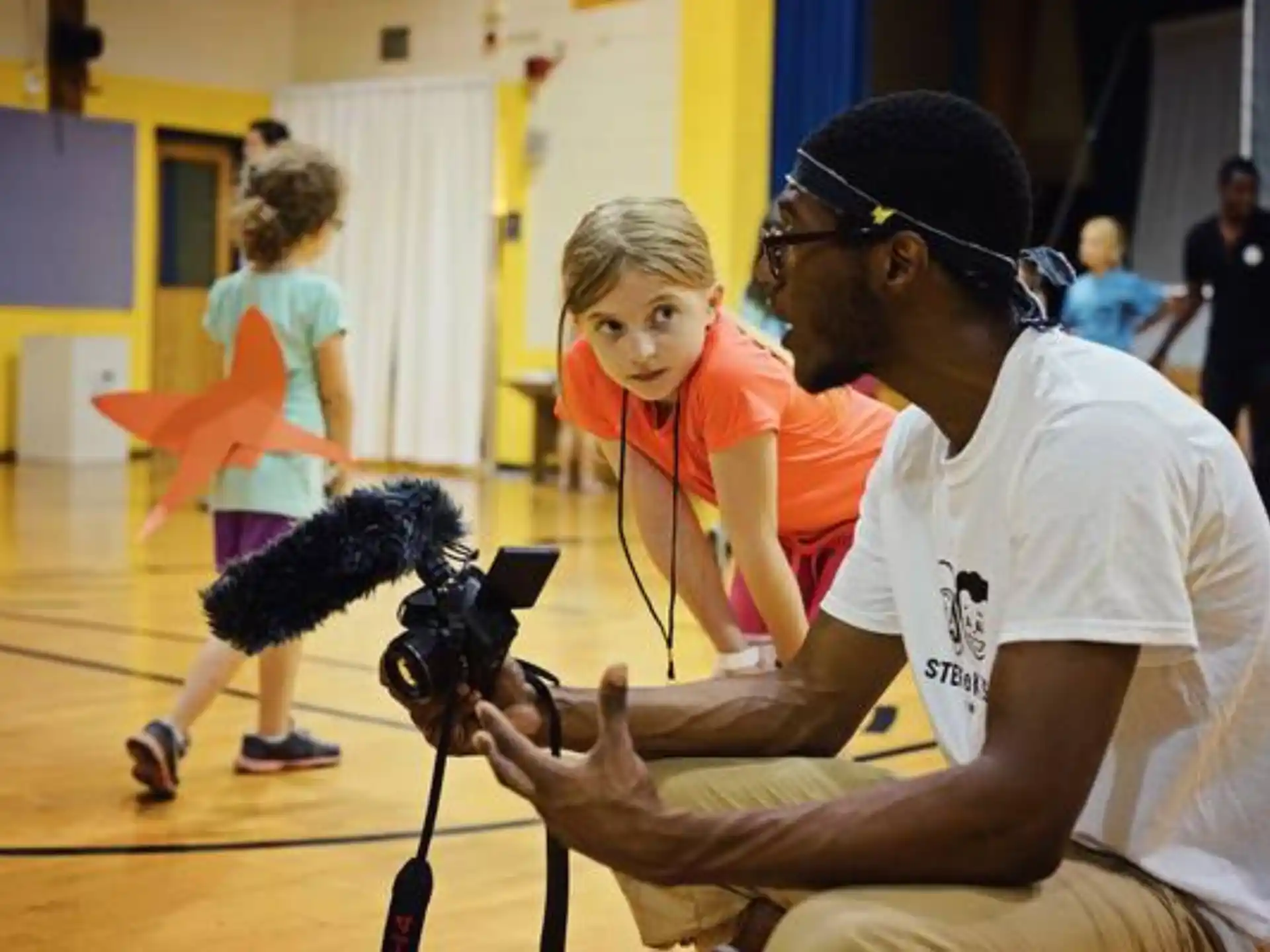 a person filming a girl with a camera