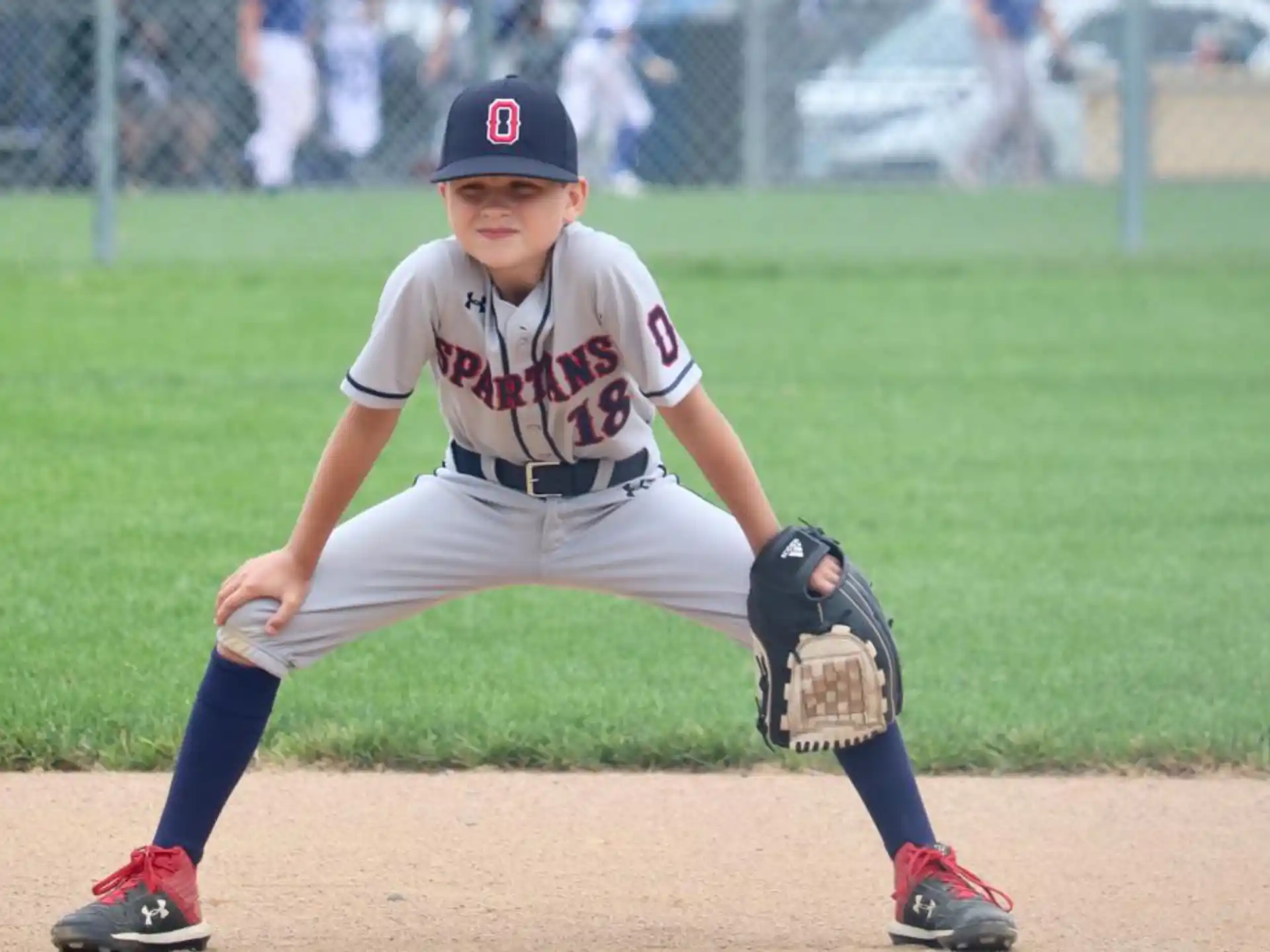 a baseball player in the middle of pitching a baseball