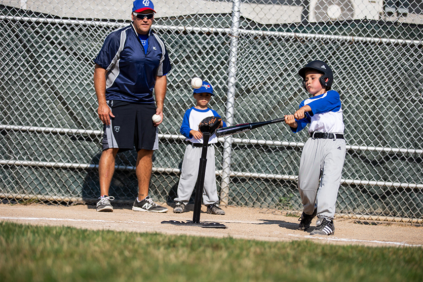 a kid holding a baseball bat
