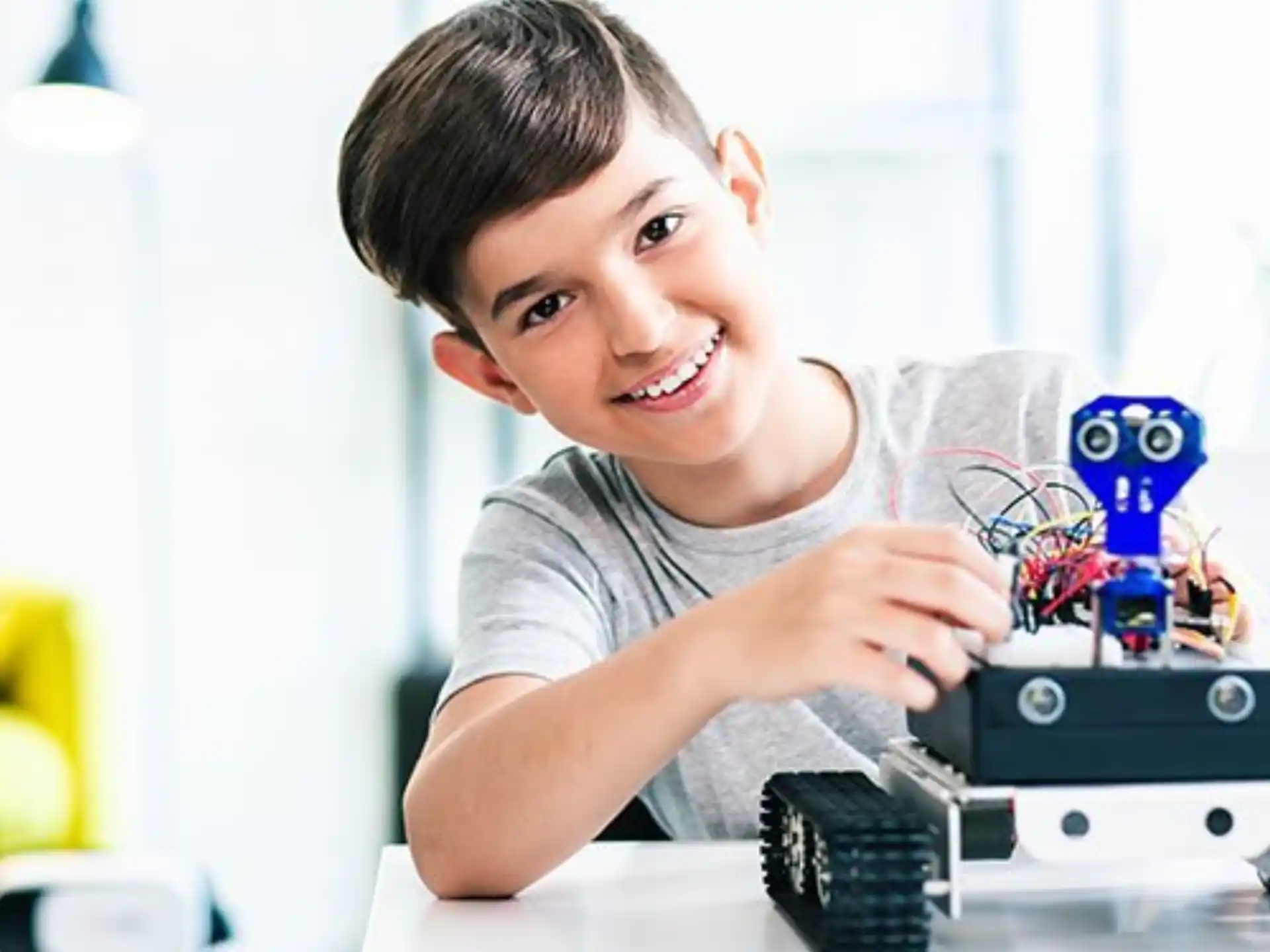 a boy smiling and playing with a toy