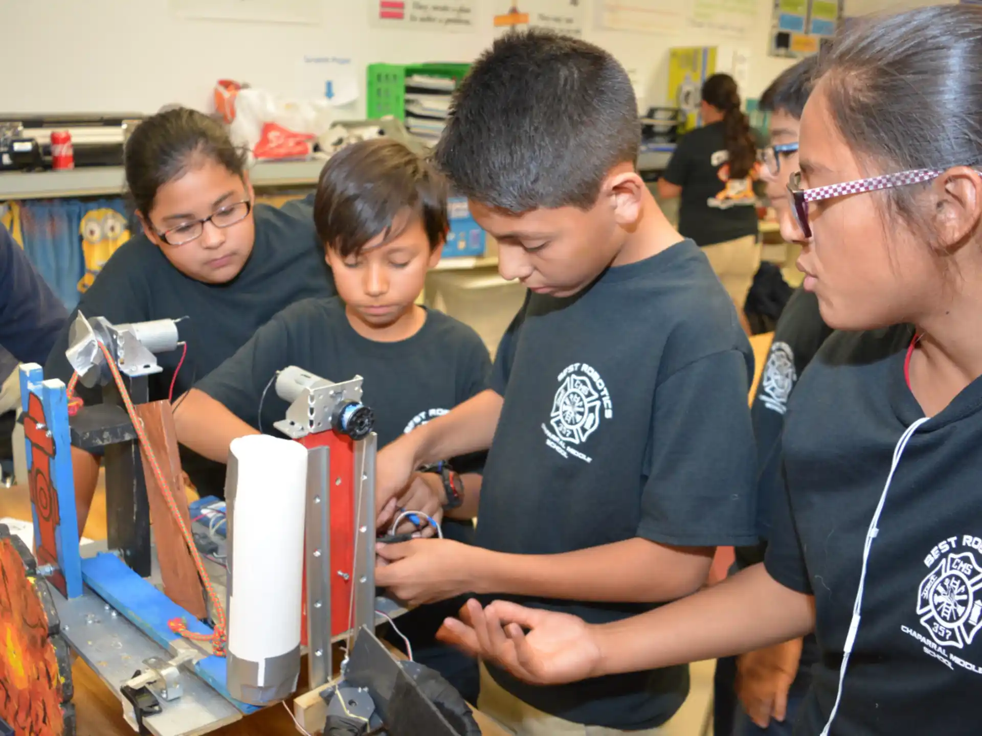 a group of people looking at a machine