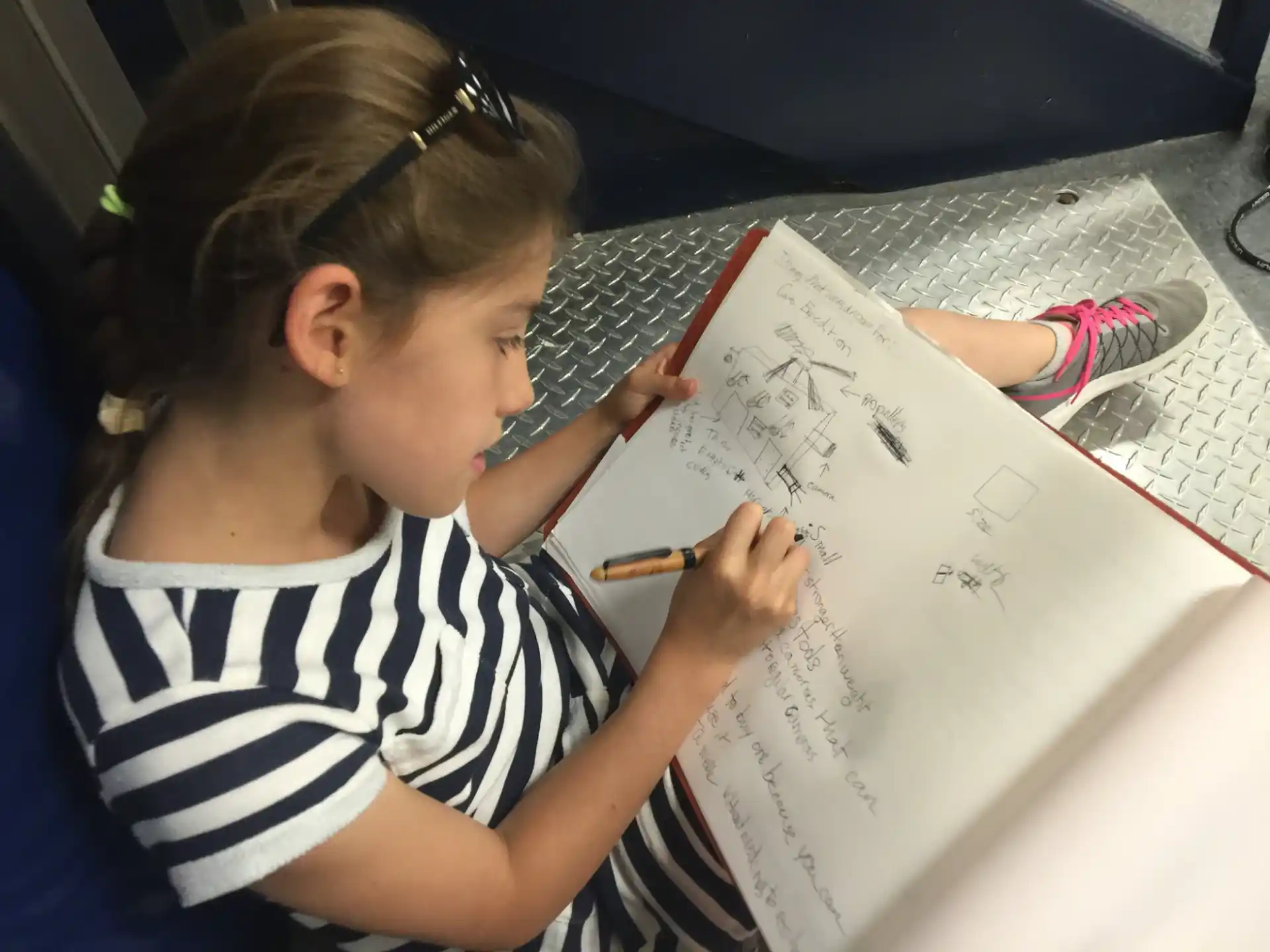 a young girl drawing on a paper