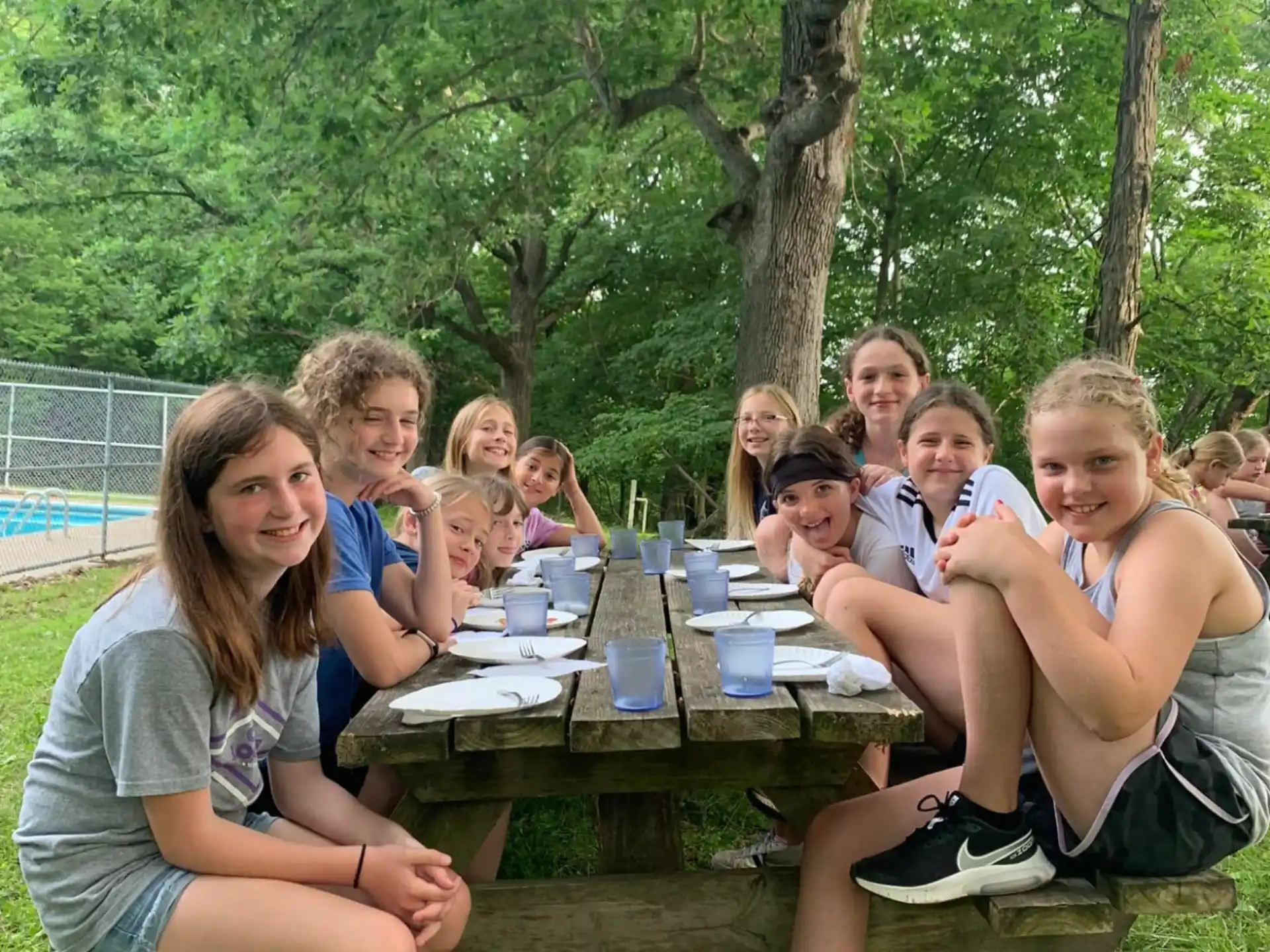 a group of people sitting at a picnic table