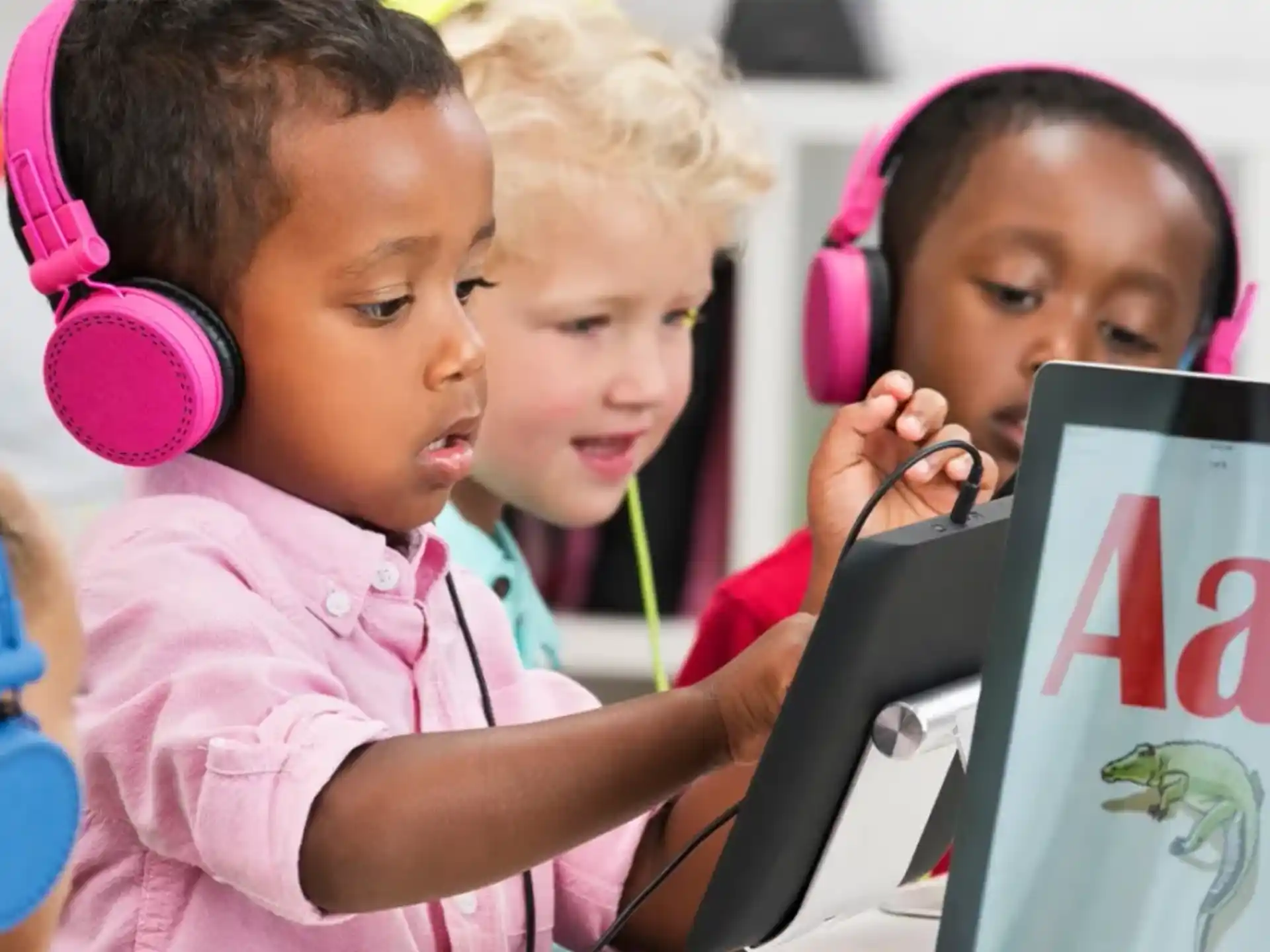 a group of children looking at a computer screen