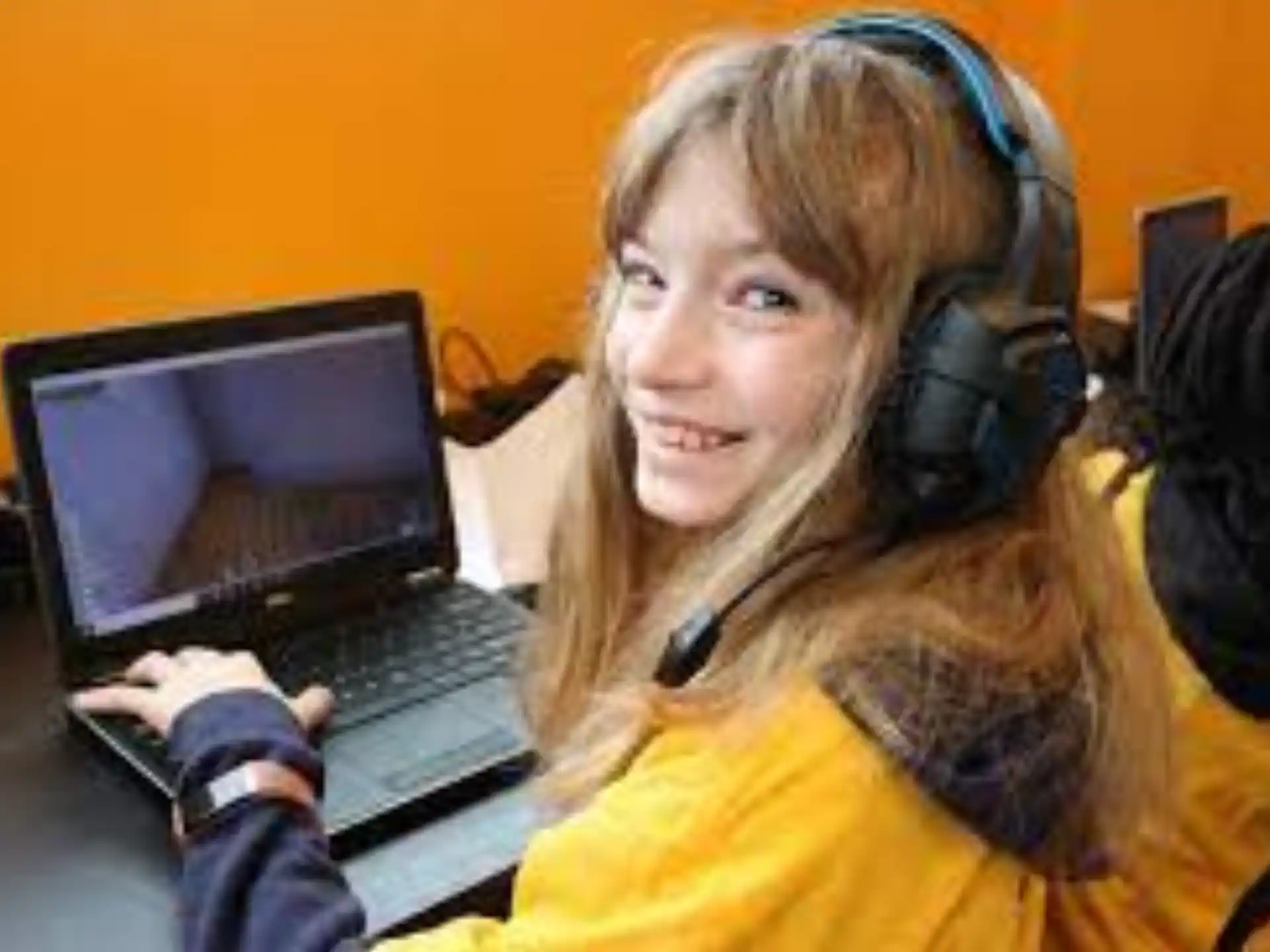 a person wearing headphones and using a laptop