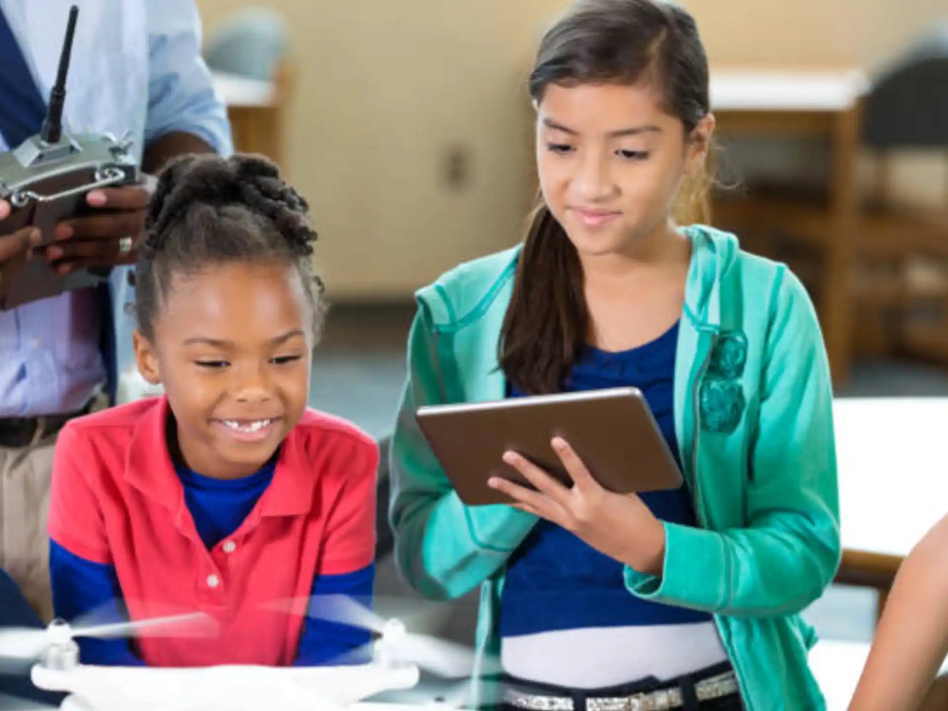 a few children looking at a tablet