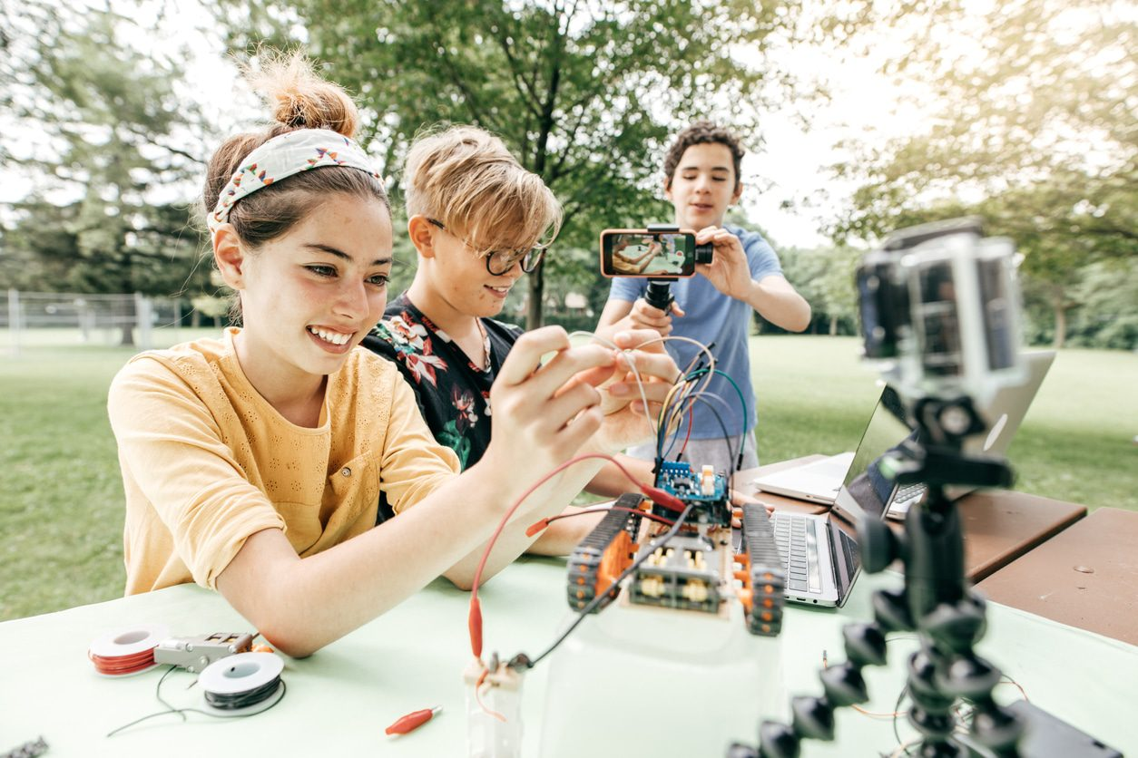 a group of people looking at a microscope