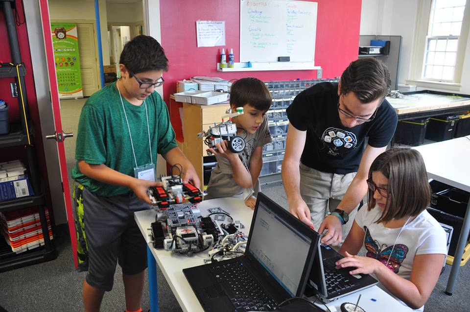 a group of people working on a laptop