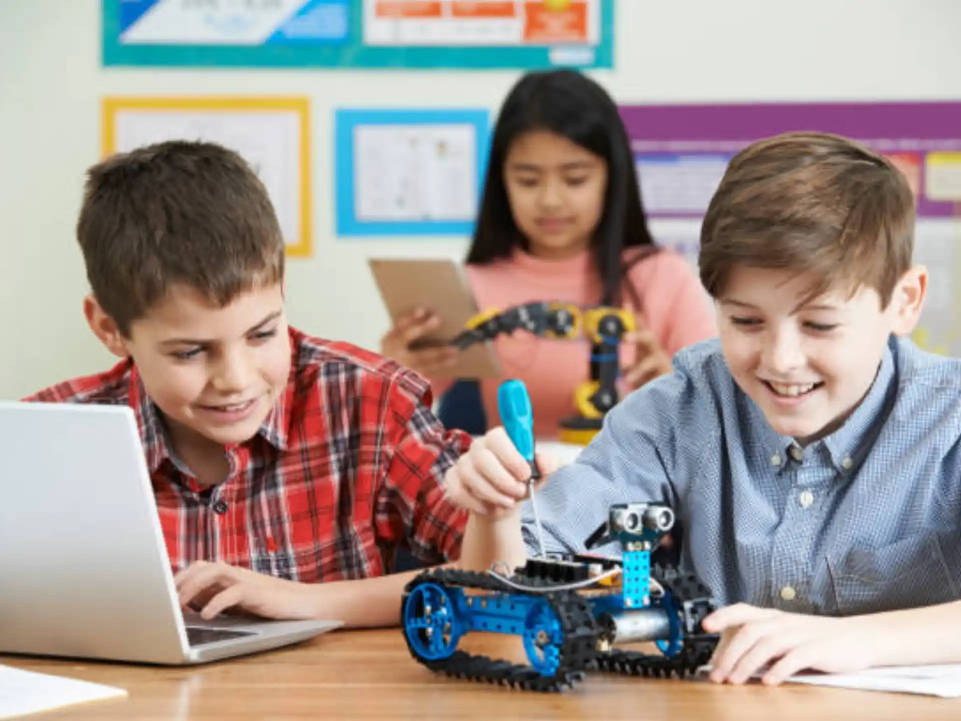 a few children working on a laptop