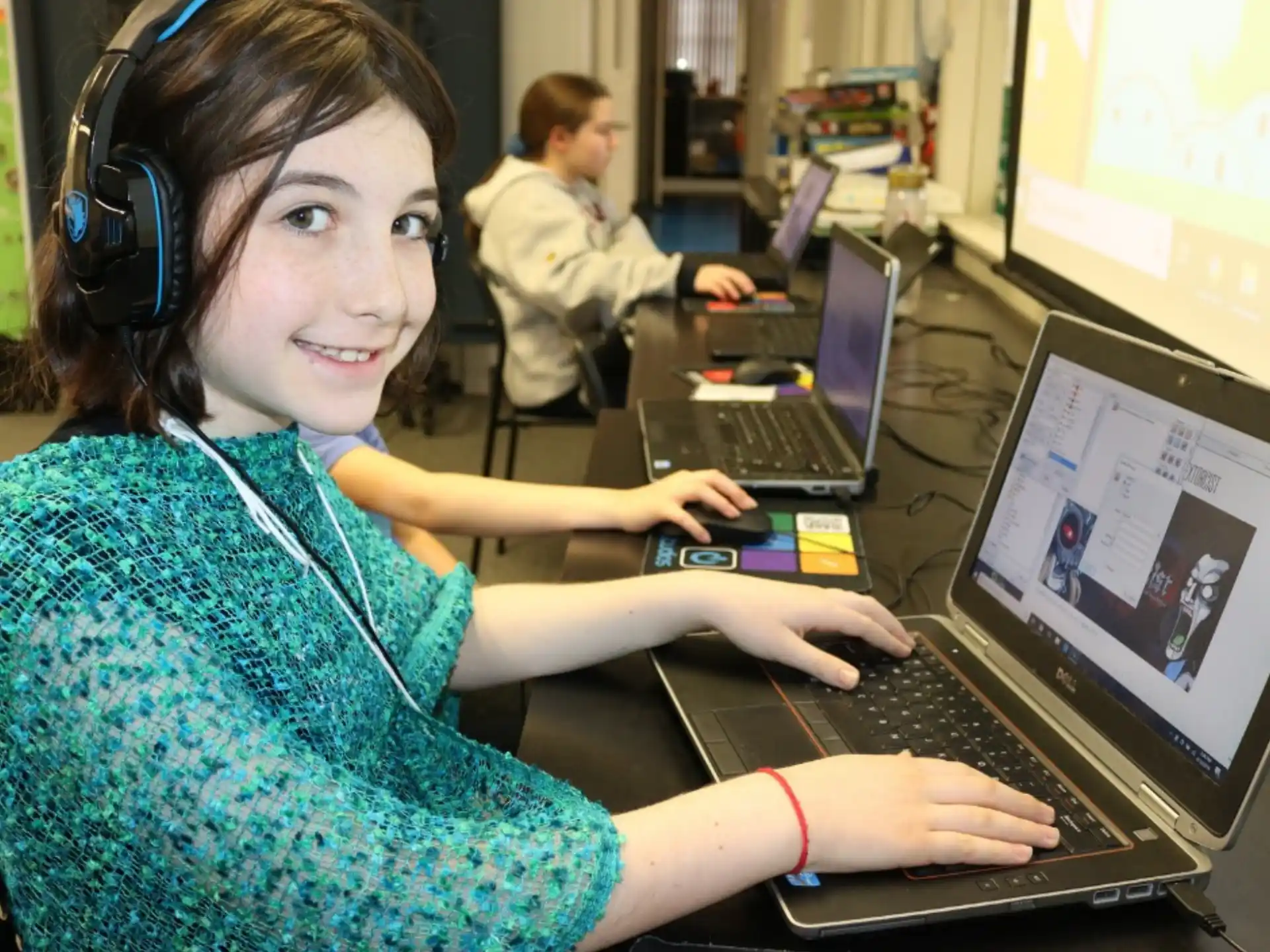 a woman wearing headphones and using a laptop
