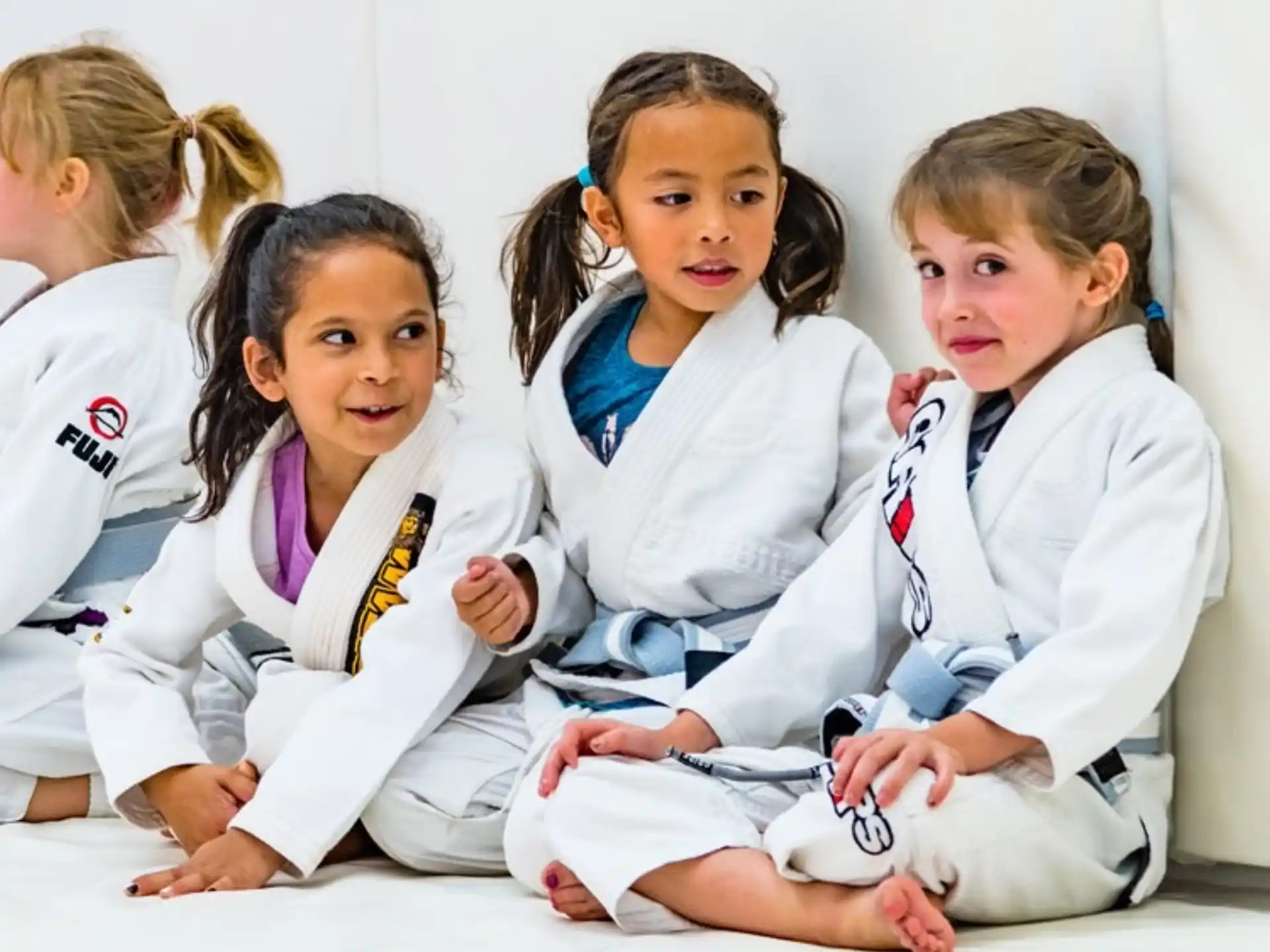 a group of girls in white uniforms