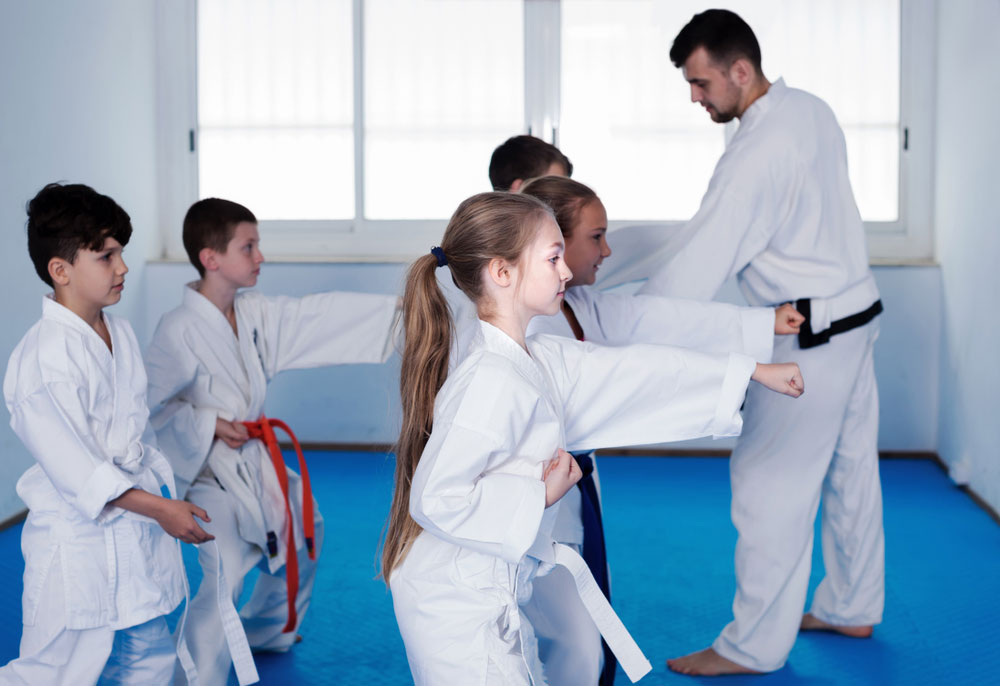 a group of people in karate uniforms
