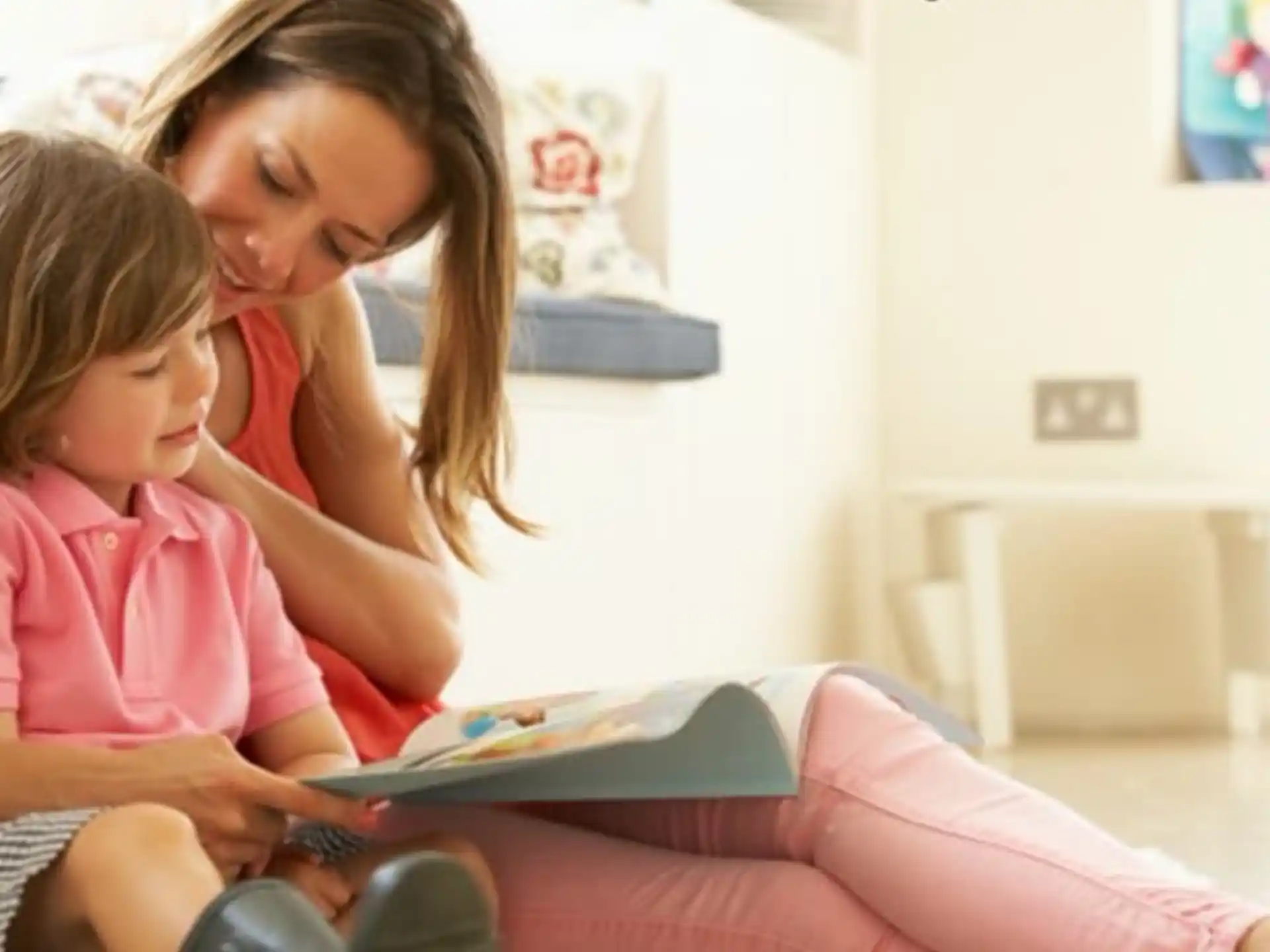 a woman reading a book to a young girl