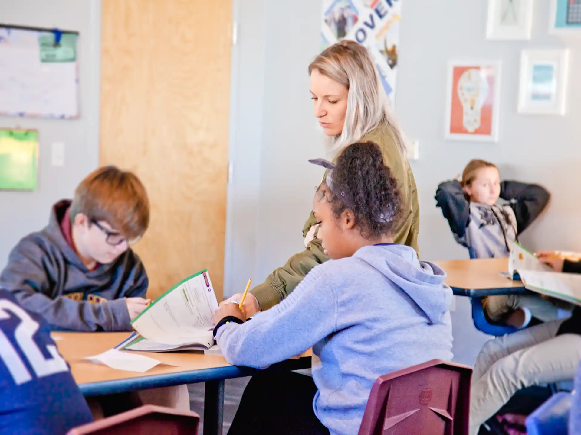 a group of people sitting at desks in a classroom