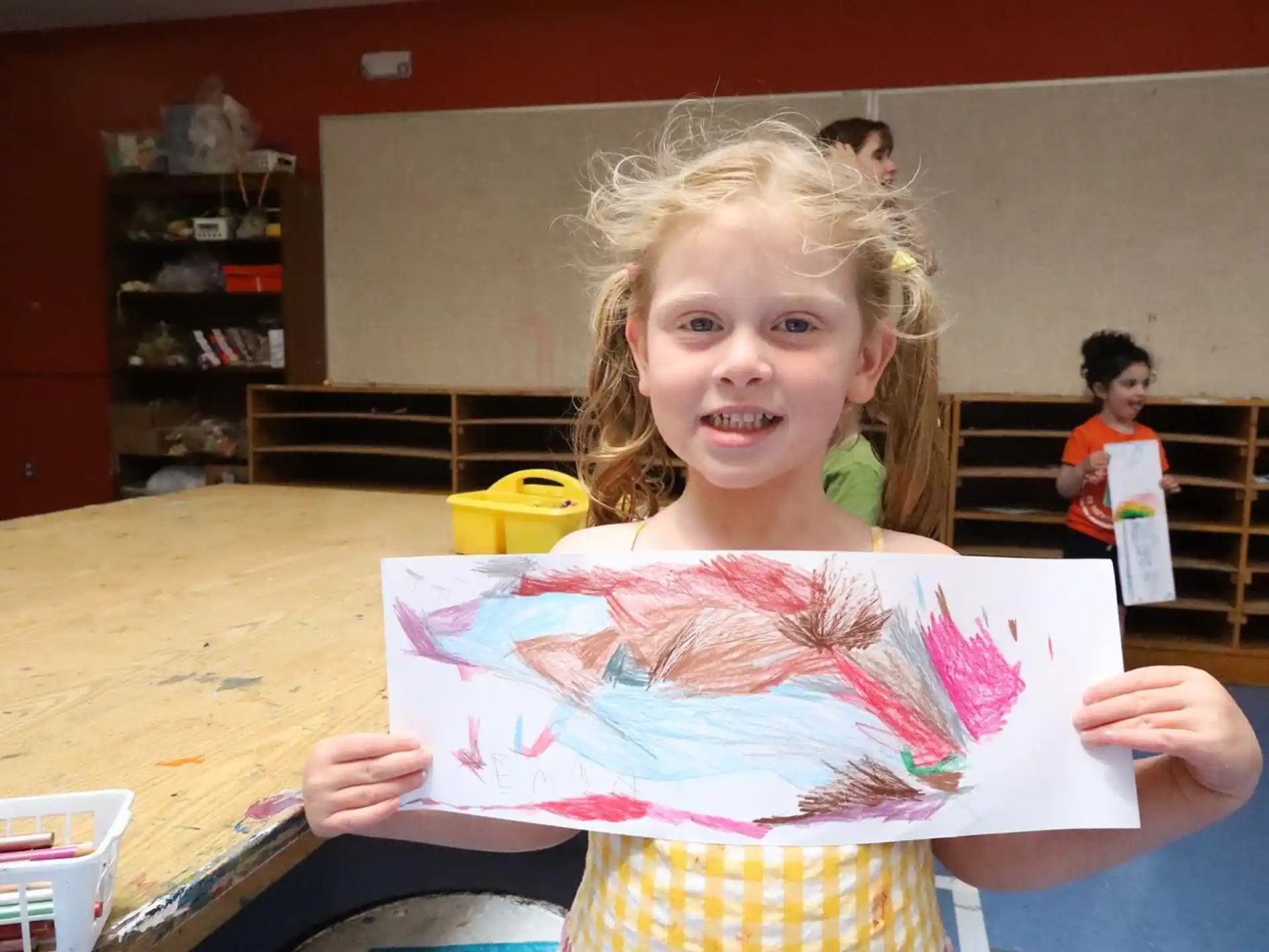a young girl holding a book