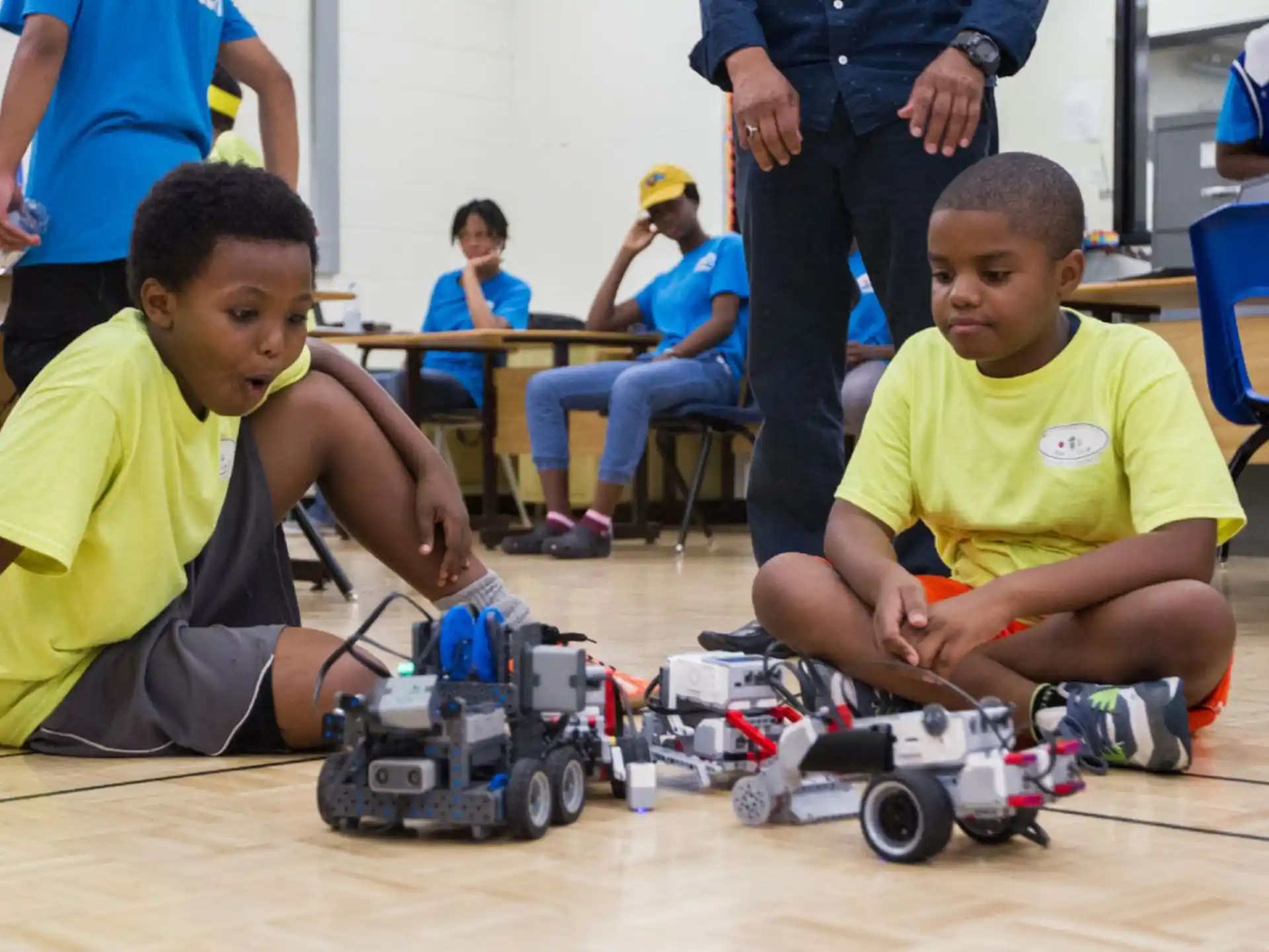 a couple of boys playing with toy cars