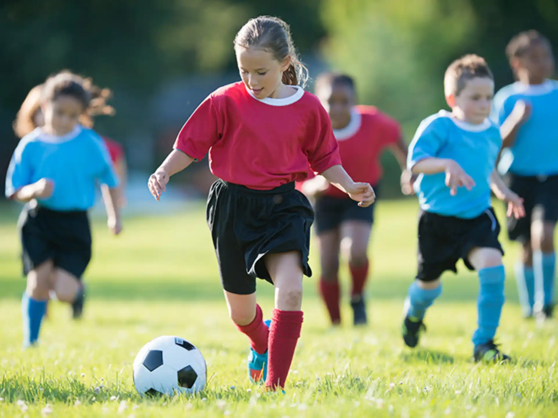 a group of kids playing football