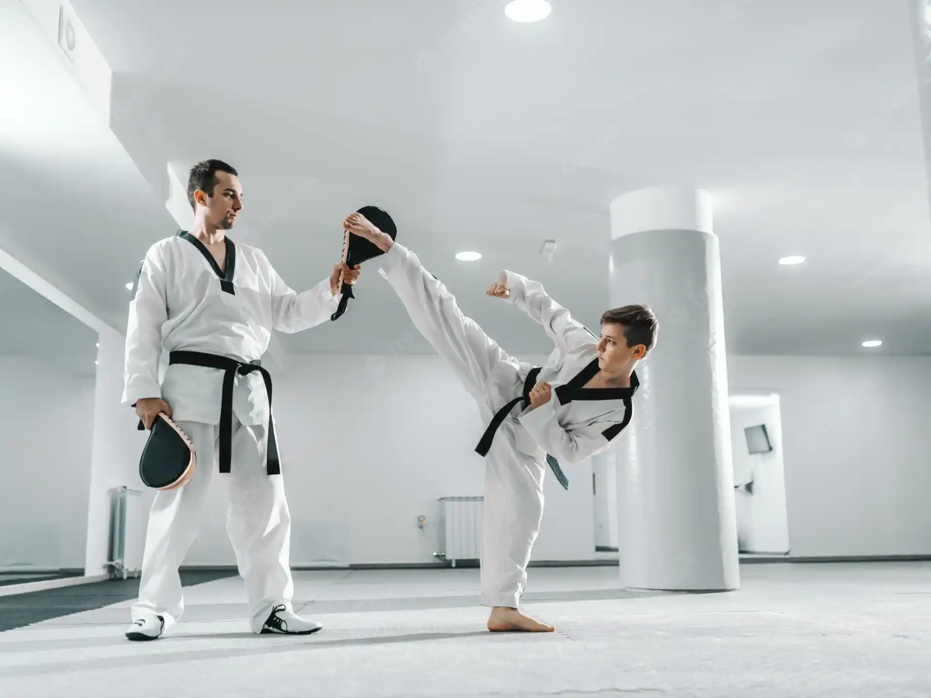 a group of people in white karate uniforms