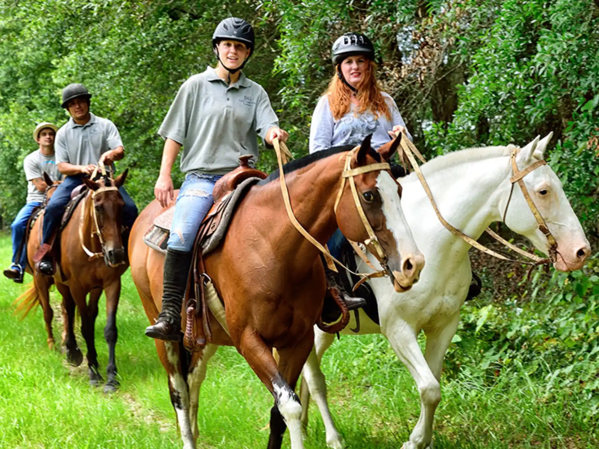 a group of people riding horses