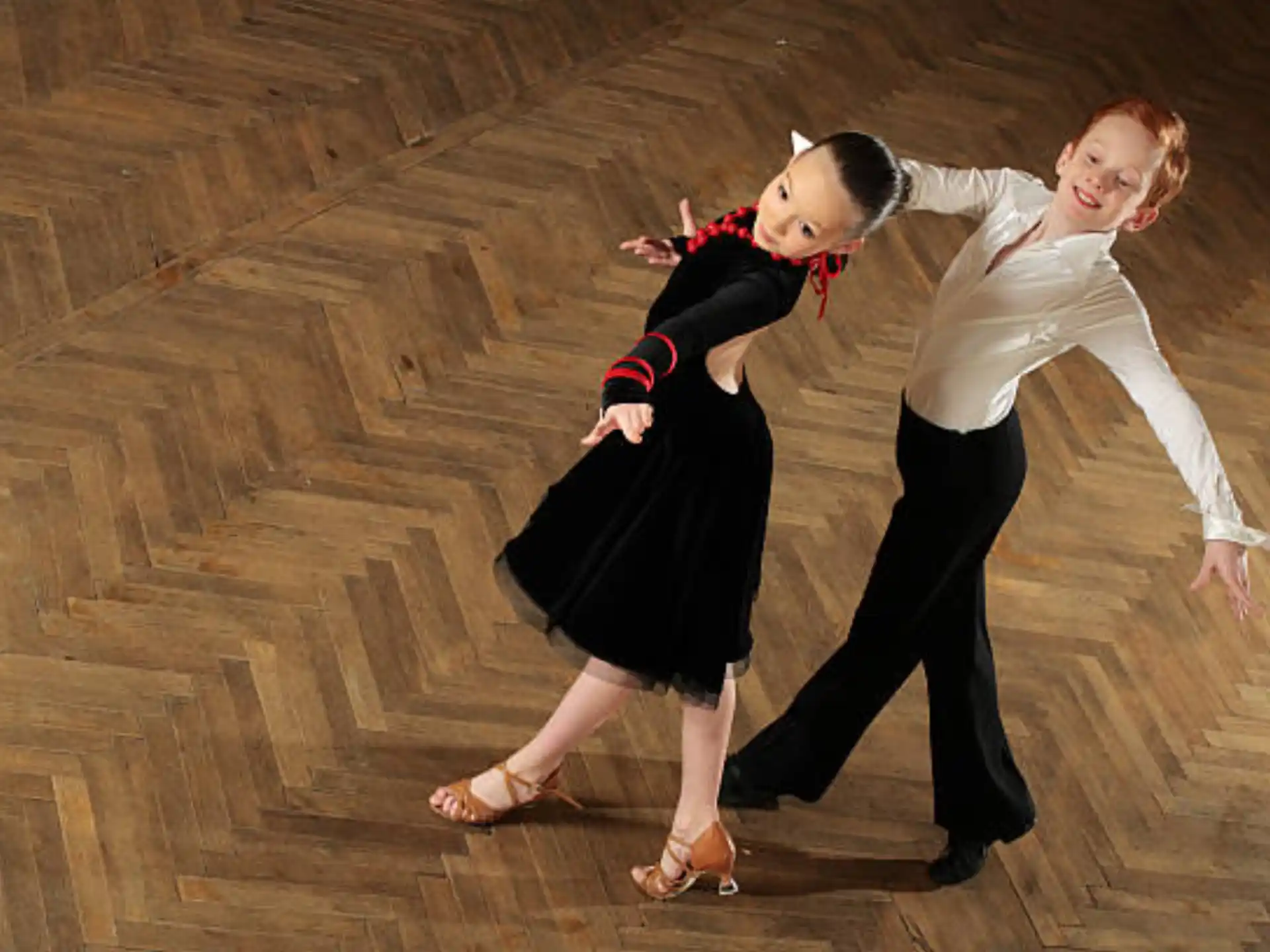 two women dancing on a wood floor