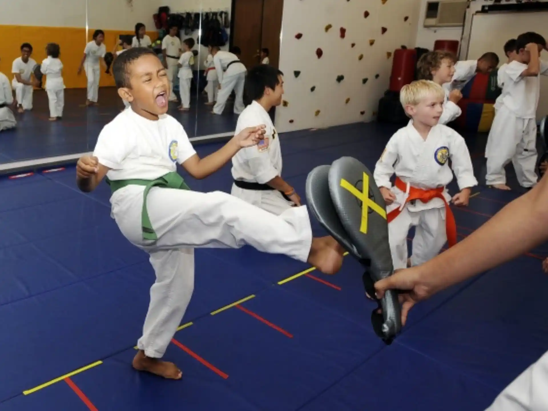 a group of kids in karate uniforms