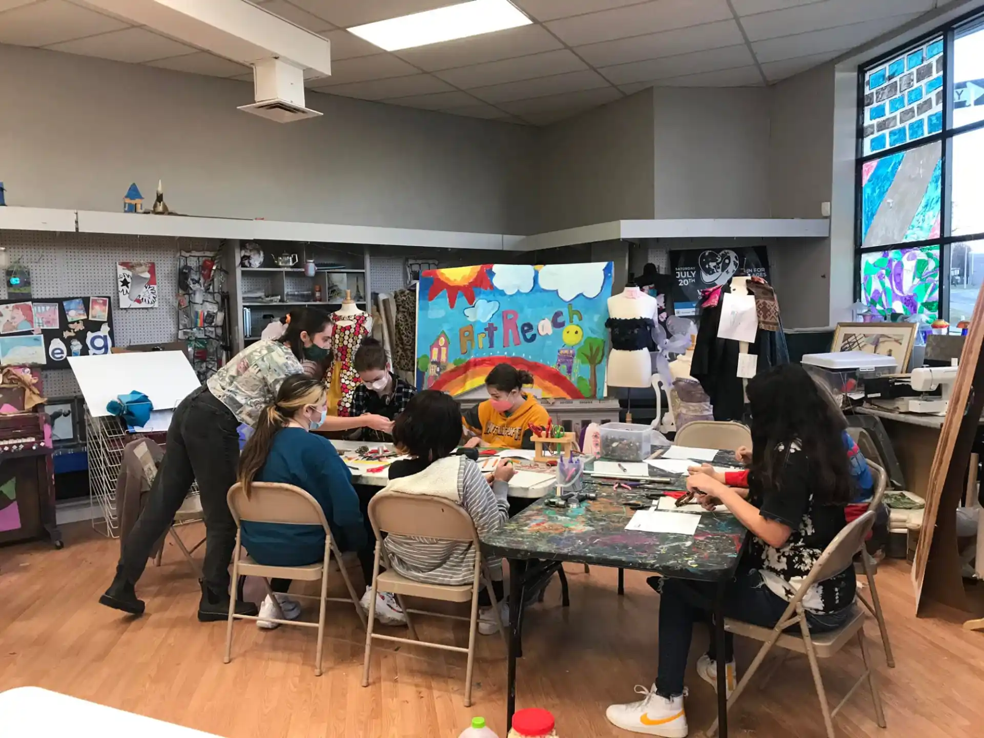 a group of people sitting at a table in a classroom