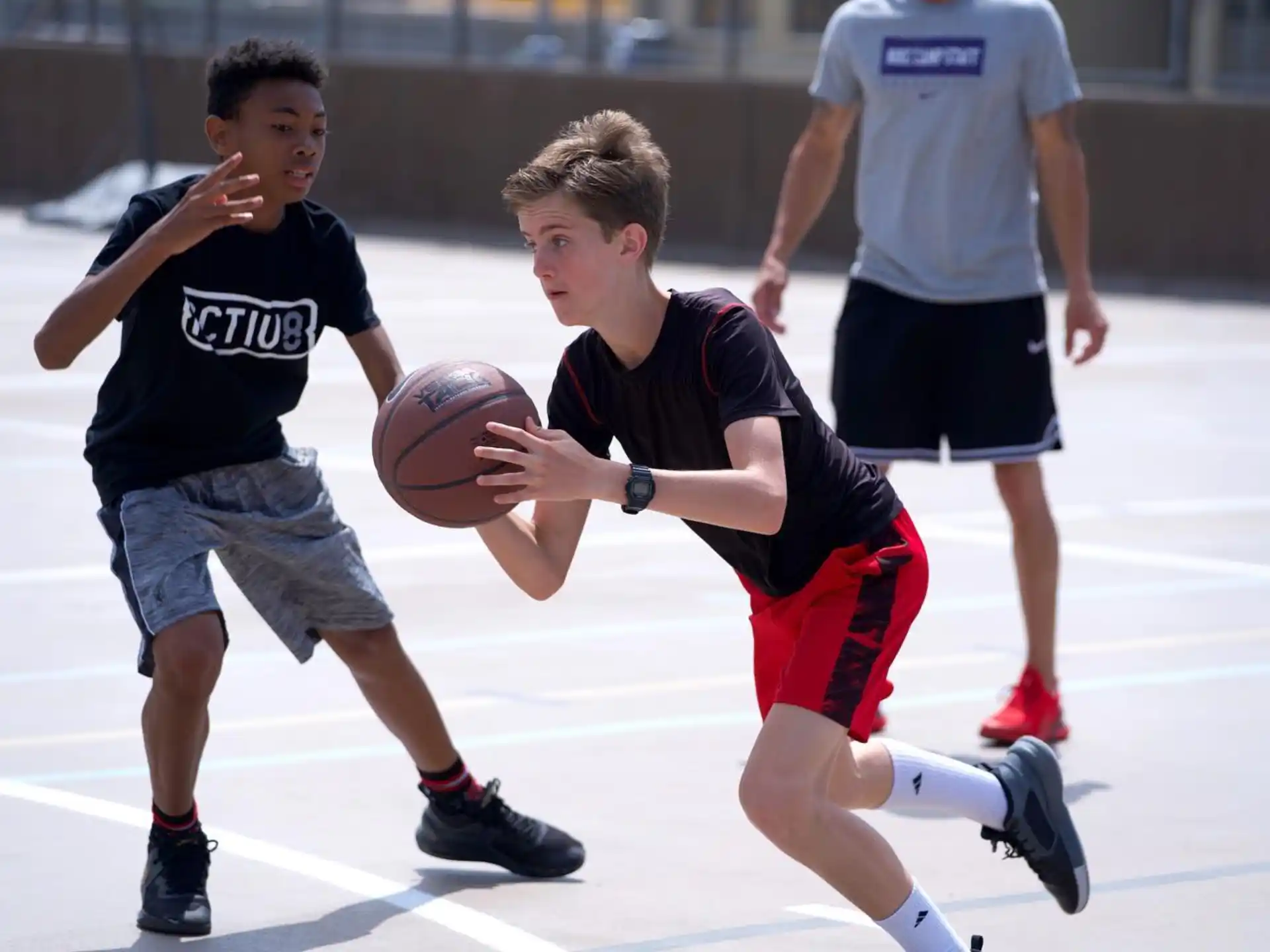 a couple of boys playing basketball