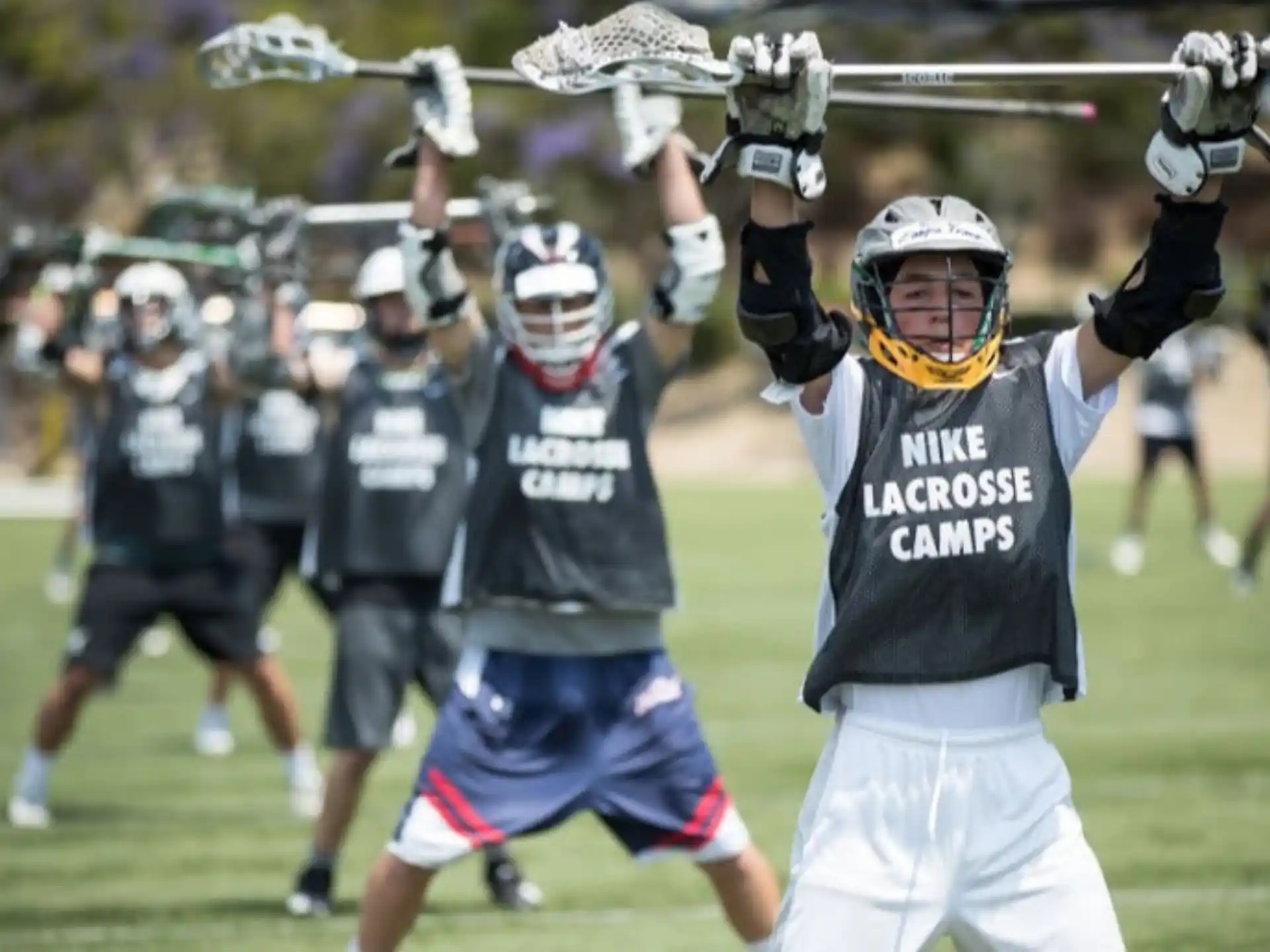 a group of people playing lacrosse