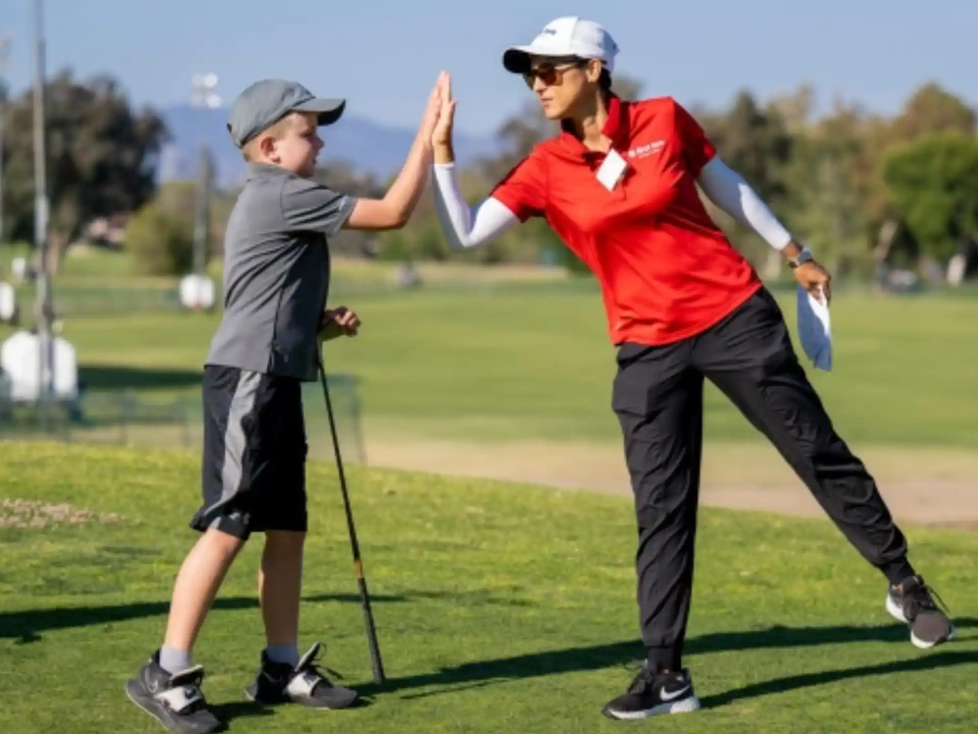 a man and a woman playing golf