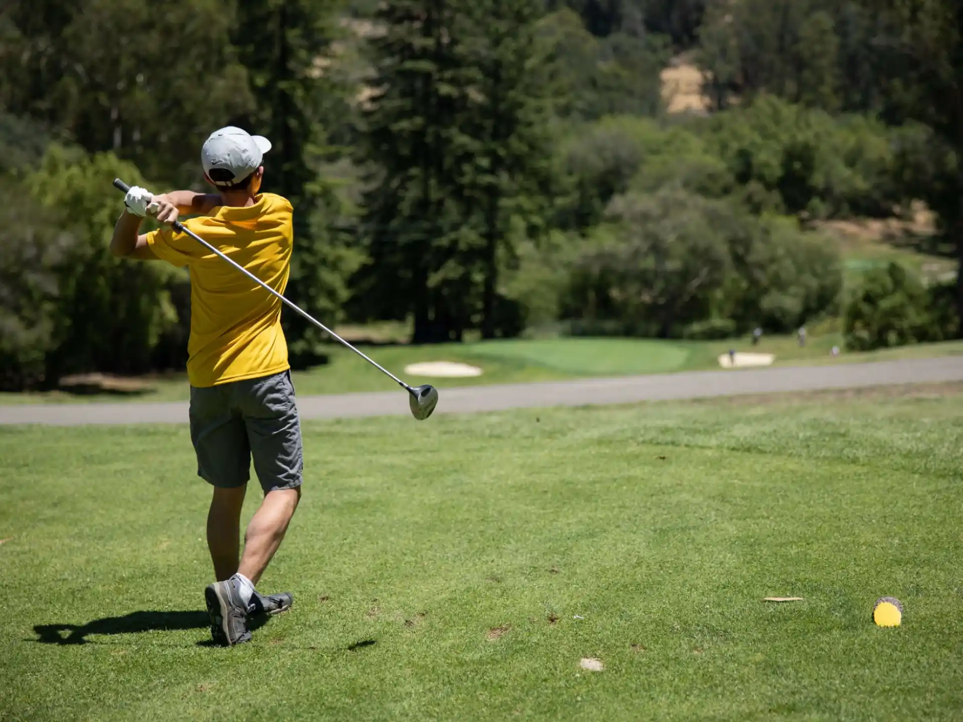 a person swinging a golf club
