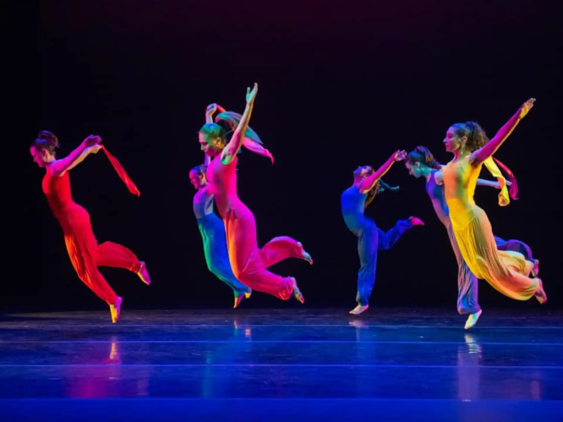 a group of people dancing on a stage