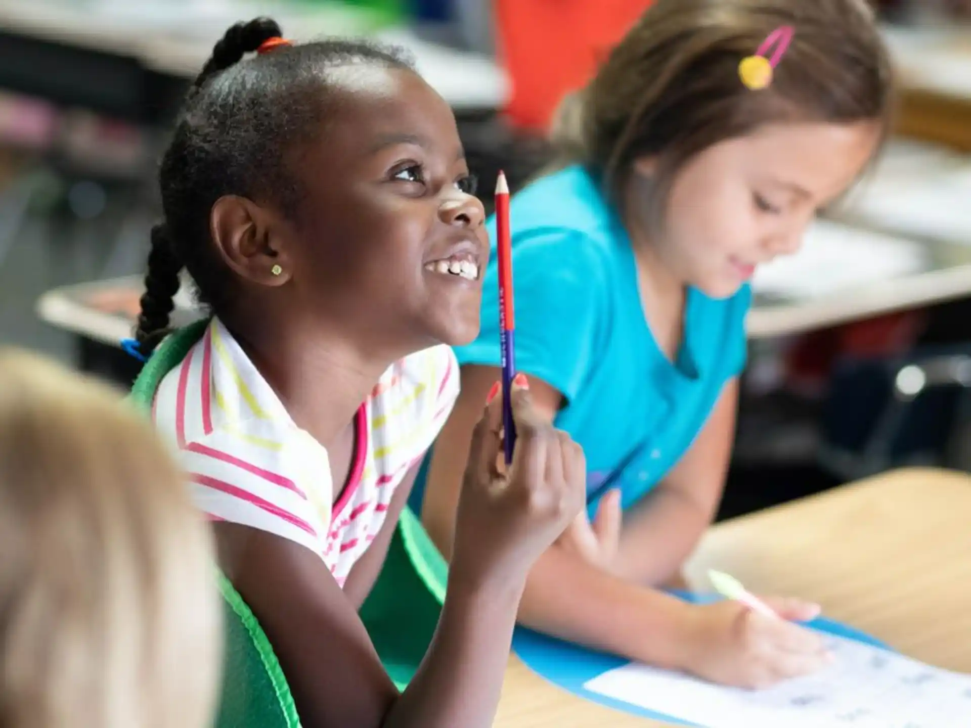 a few young girls in a classroom