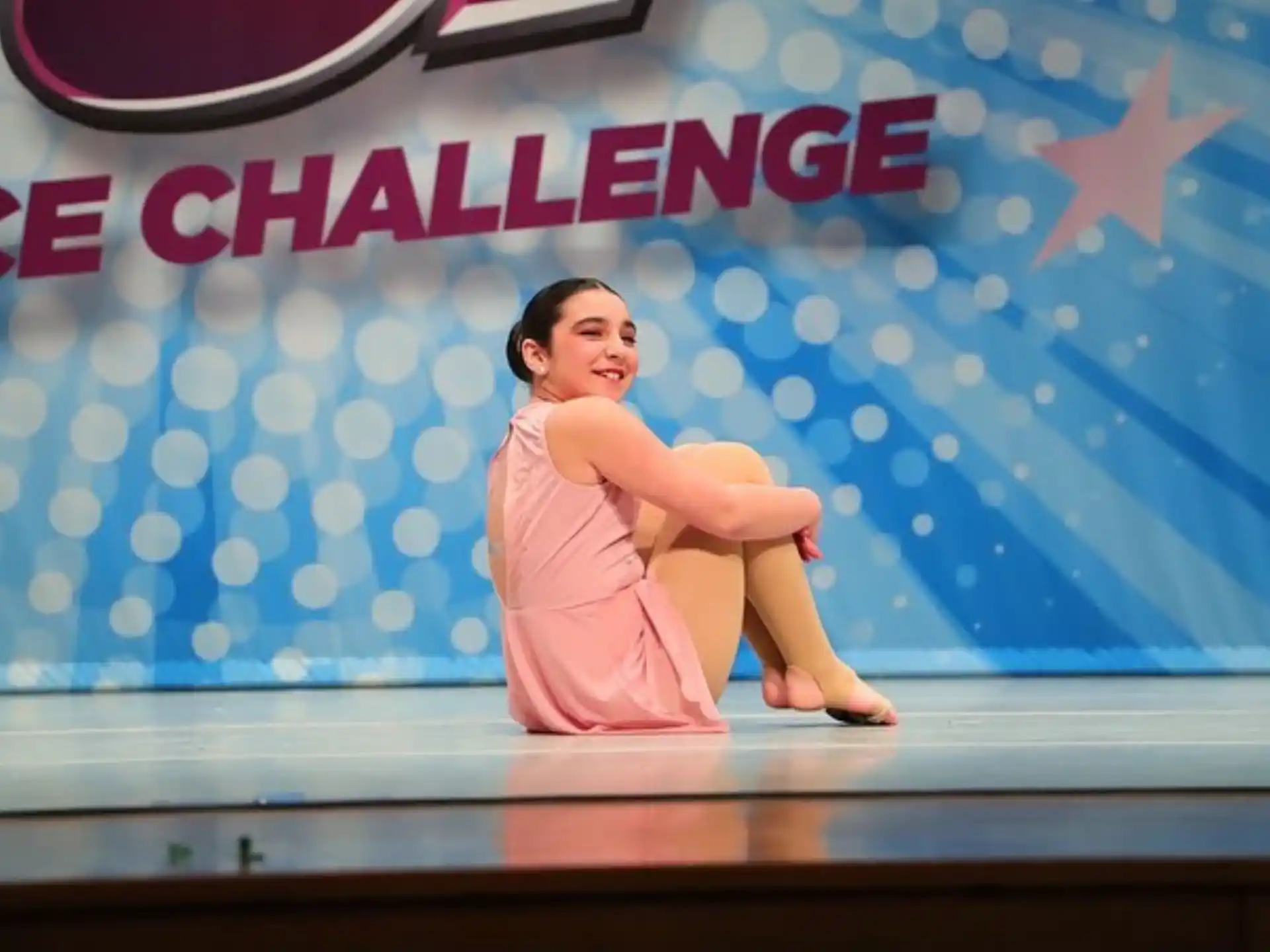a woman sitting on a stage