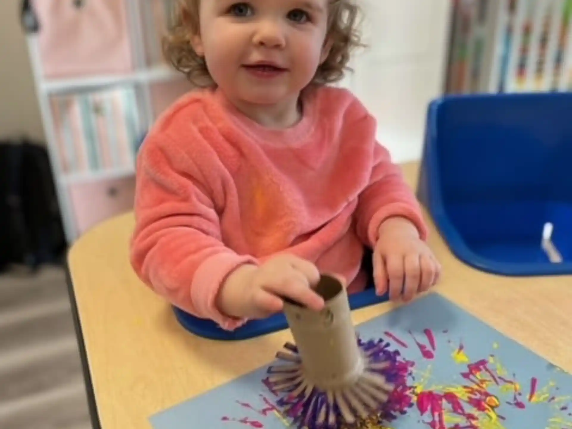 a girl sitting at a table