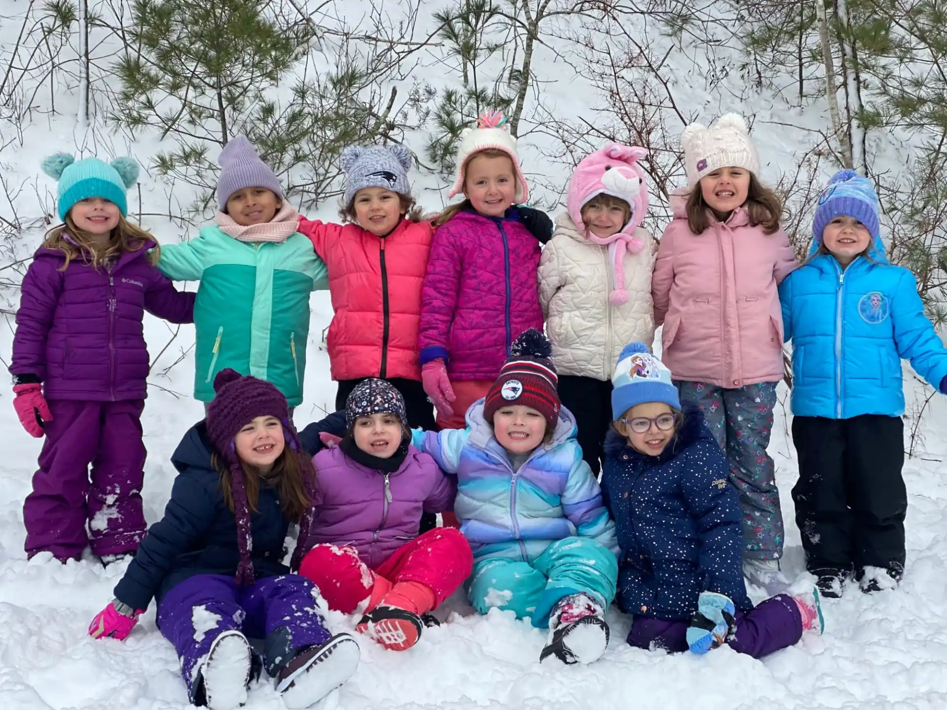 a group of children in snow gear