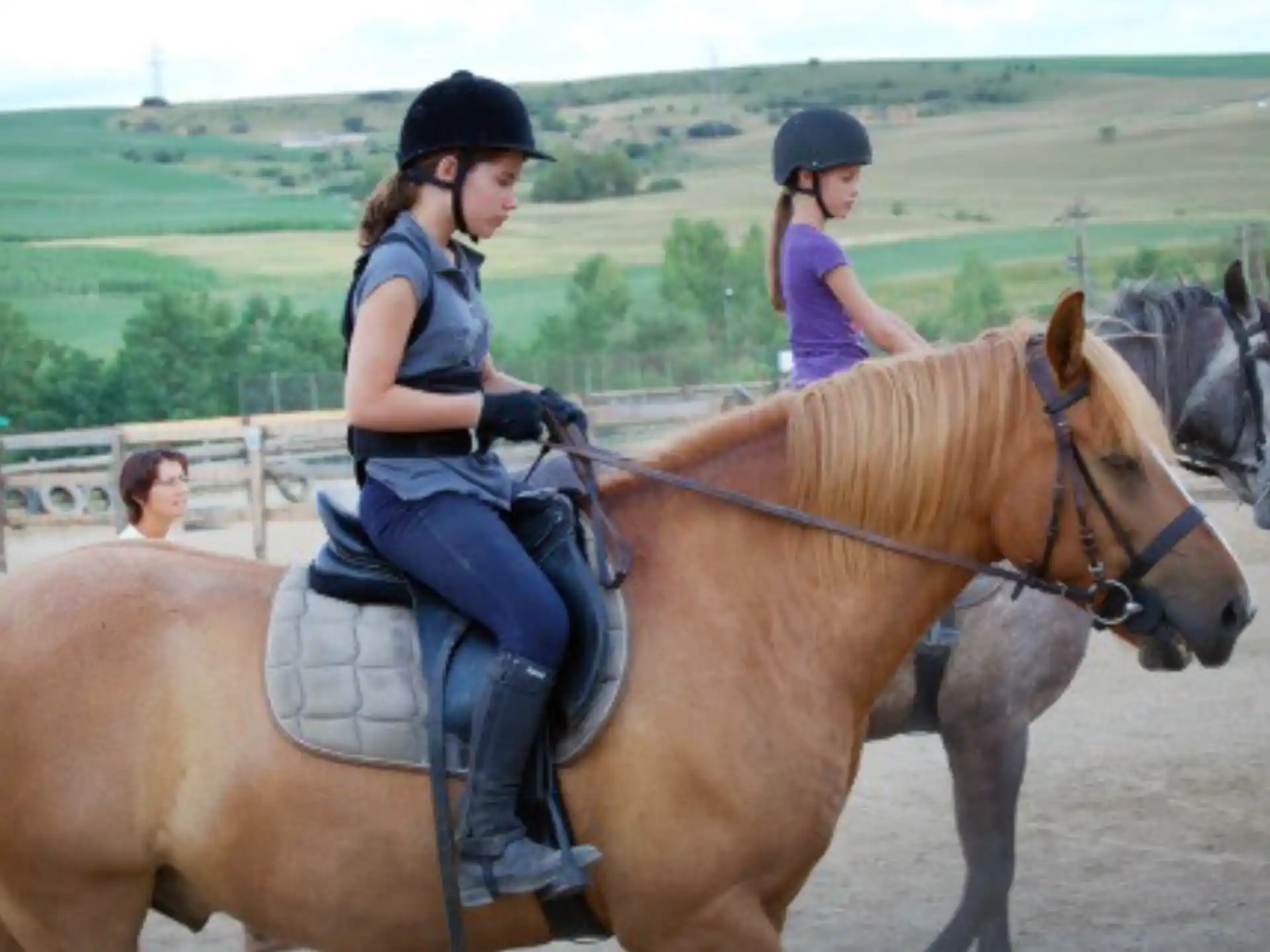 a couple of girls riding horses