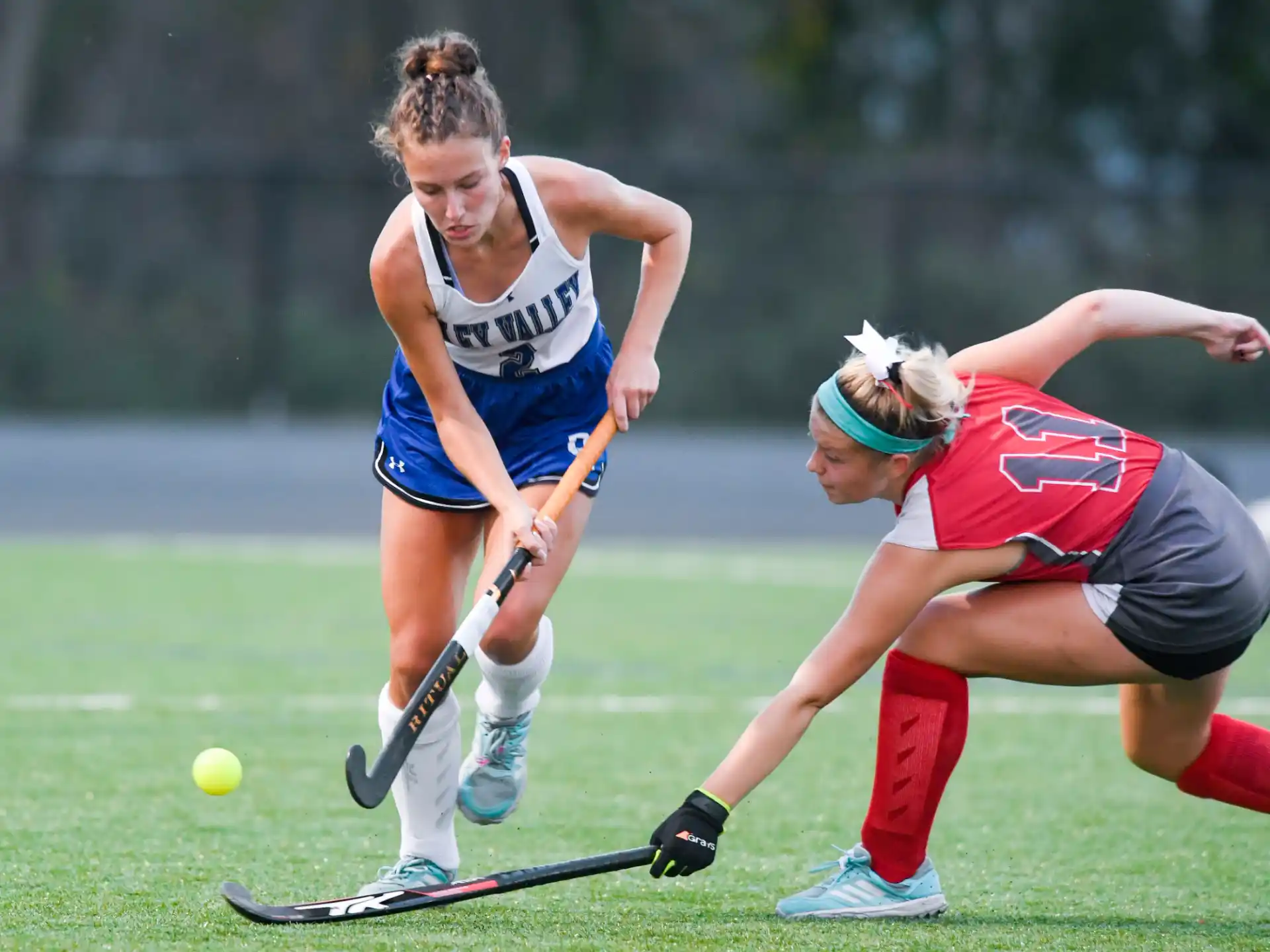 women playing field hockey