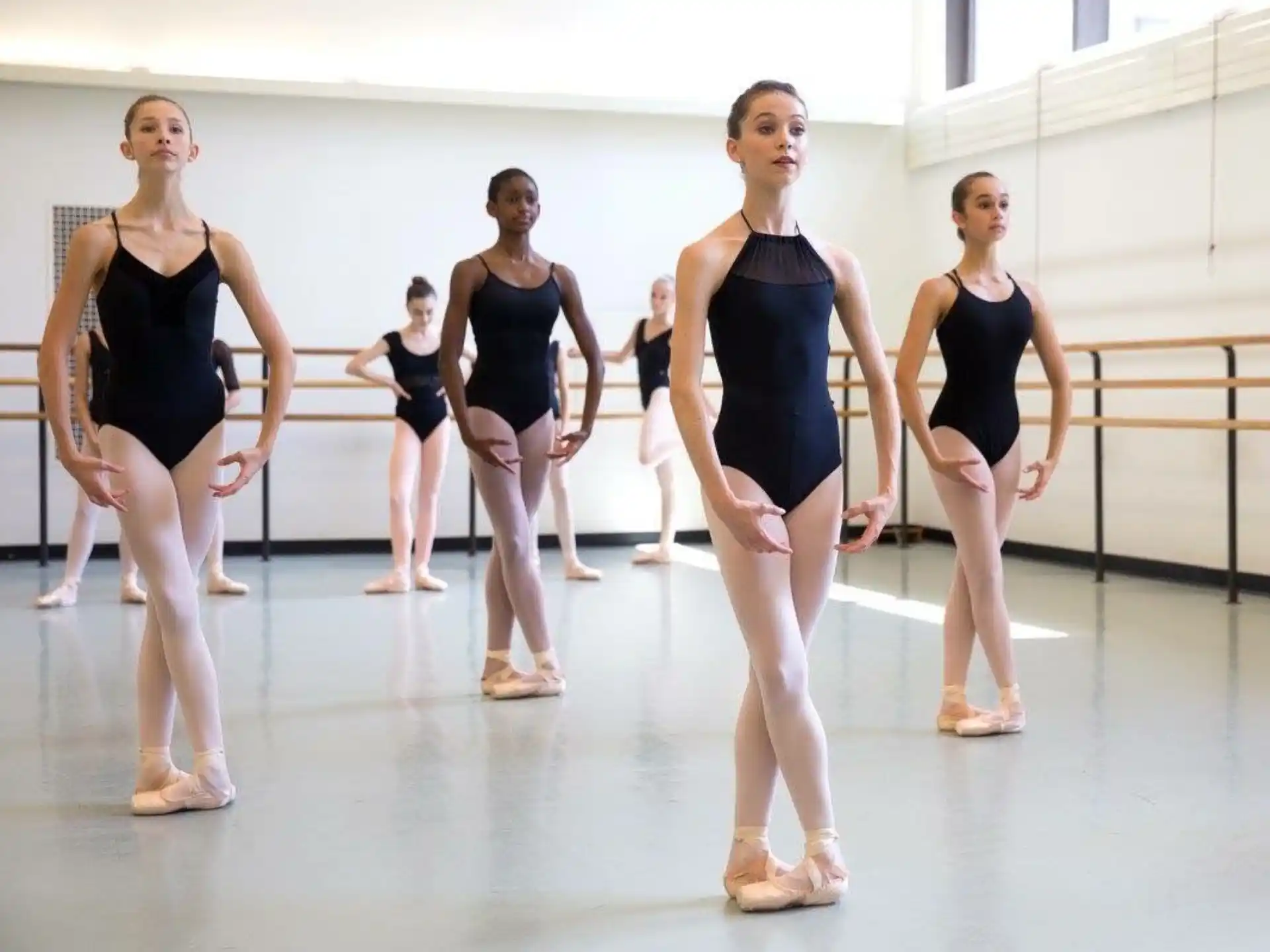 a group of women in leotards on a stage