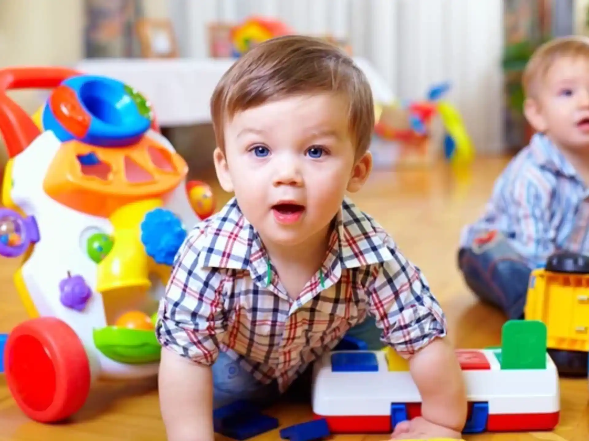a couple of babies playing with toys