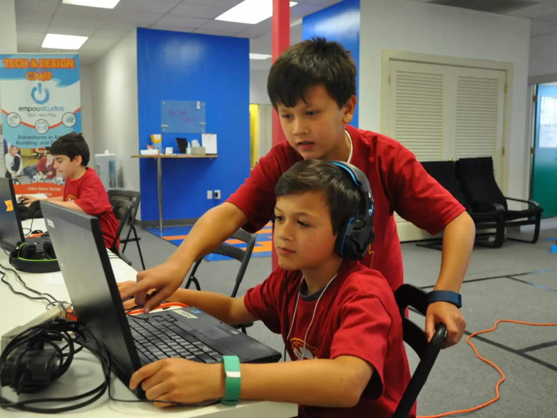 a few boys working on a computer