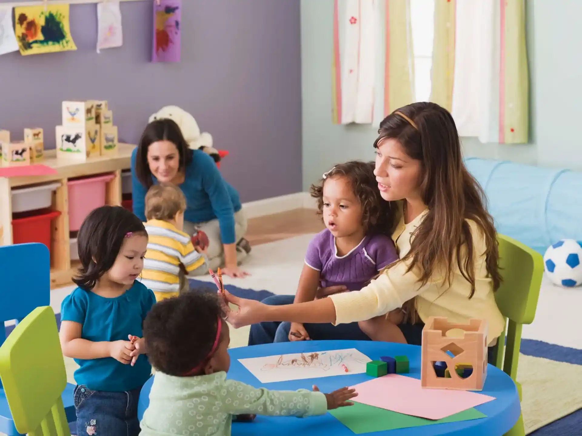 a person and several children in a classroom