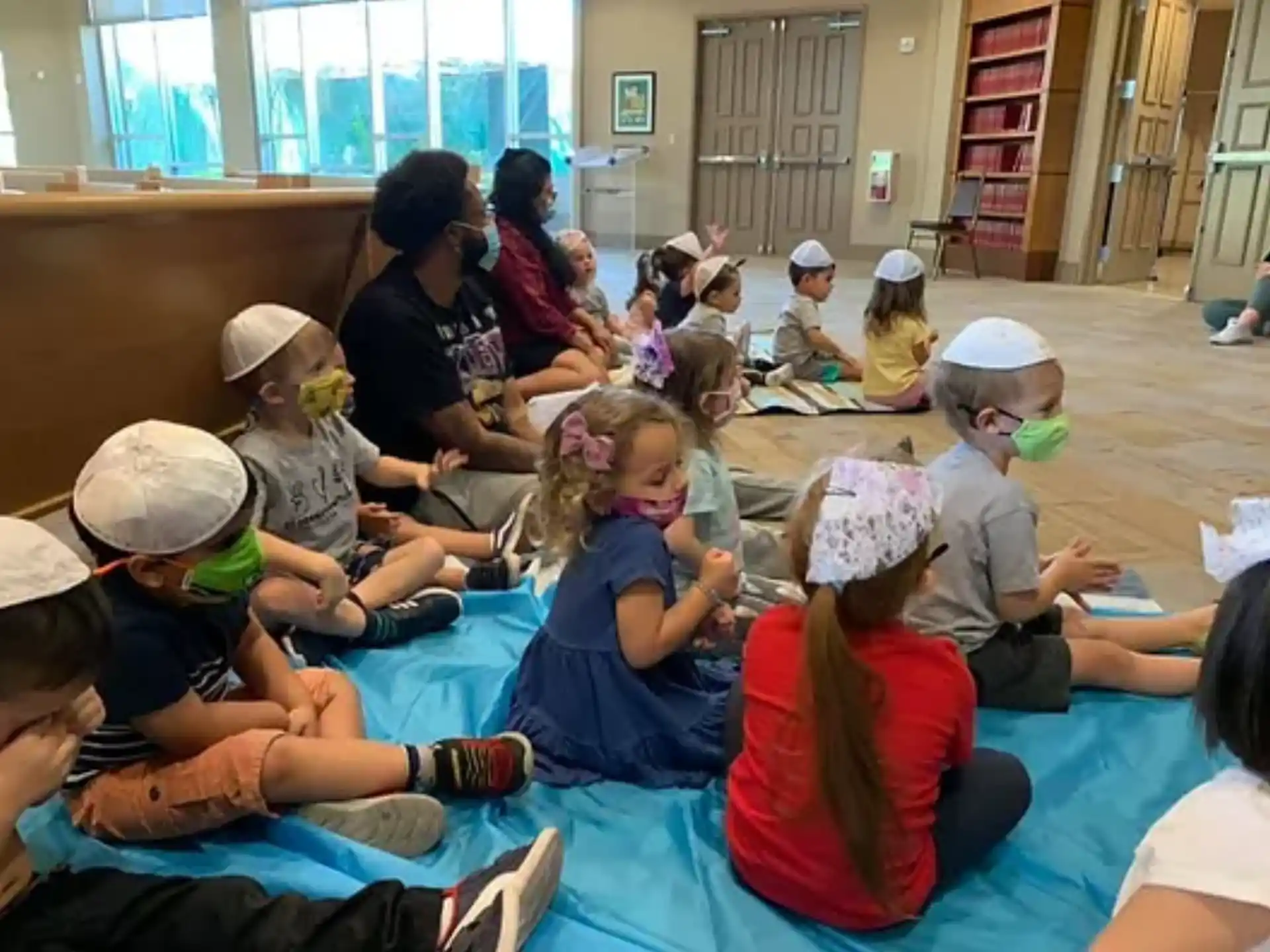 a group of children sitting on the floor