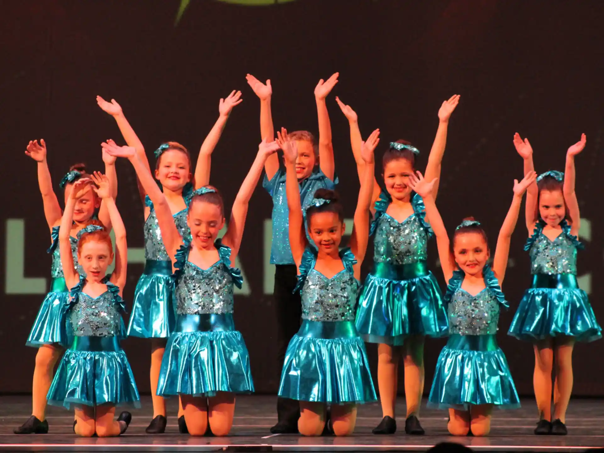 a group of girls in blue dresses