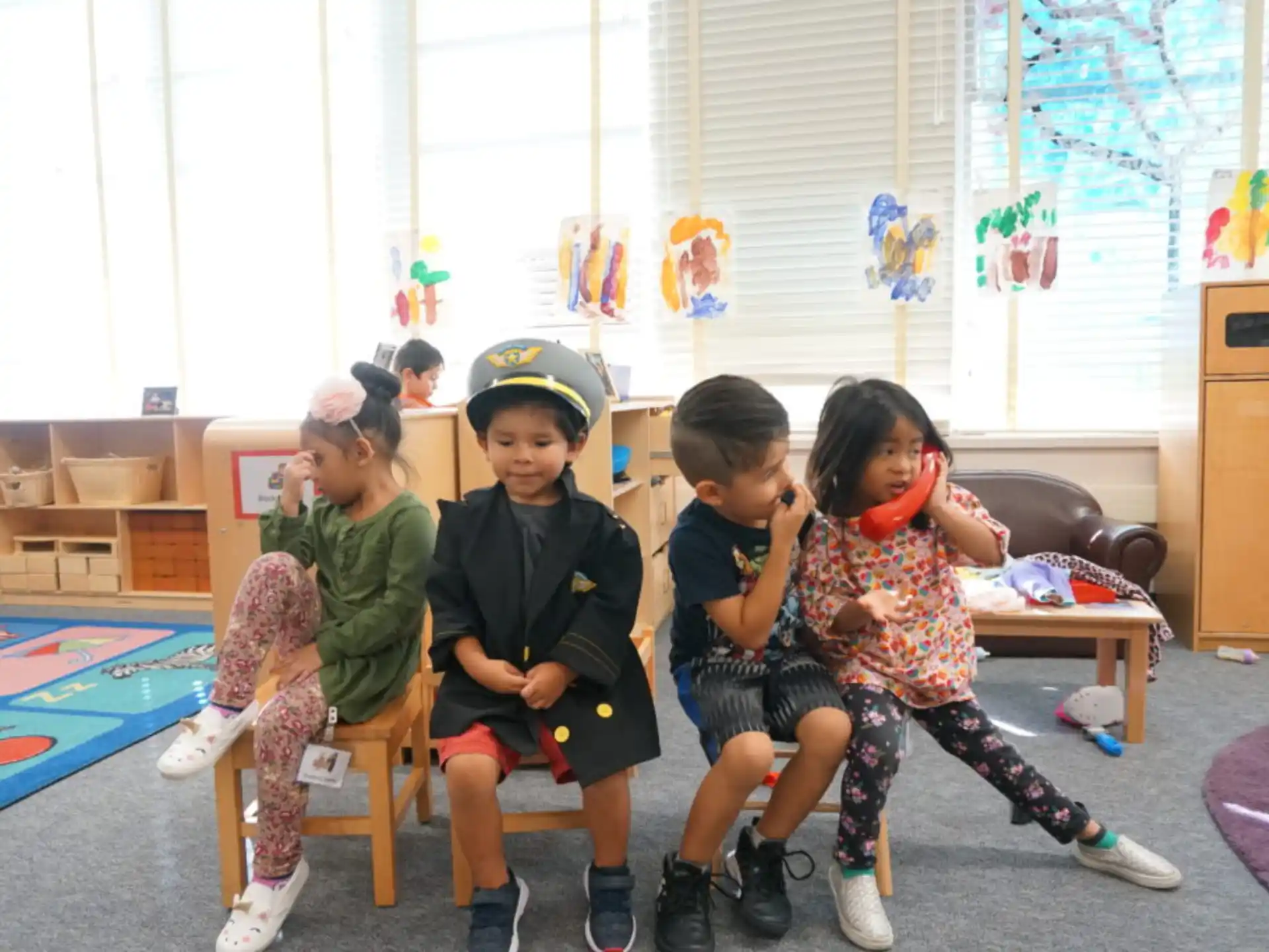 a group of children sitting on chairs