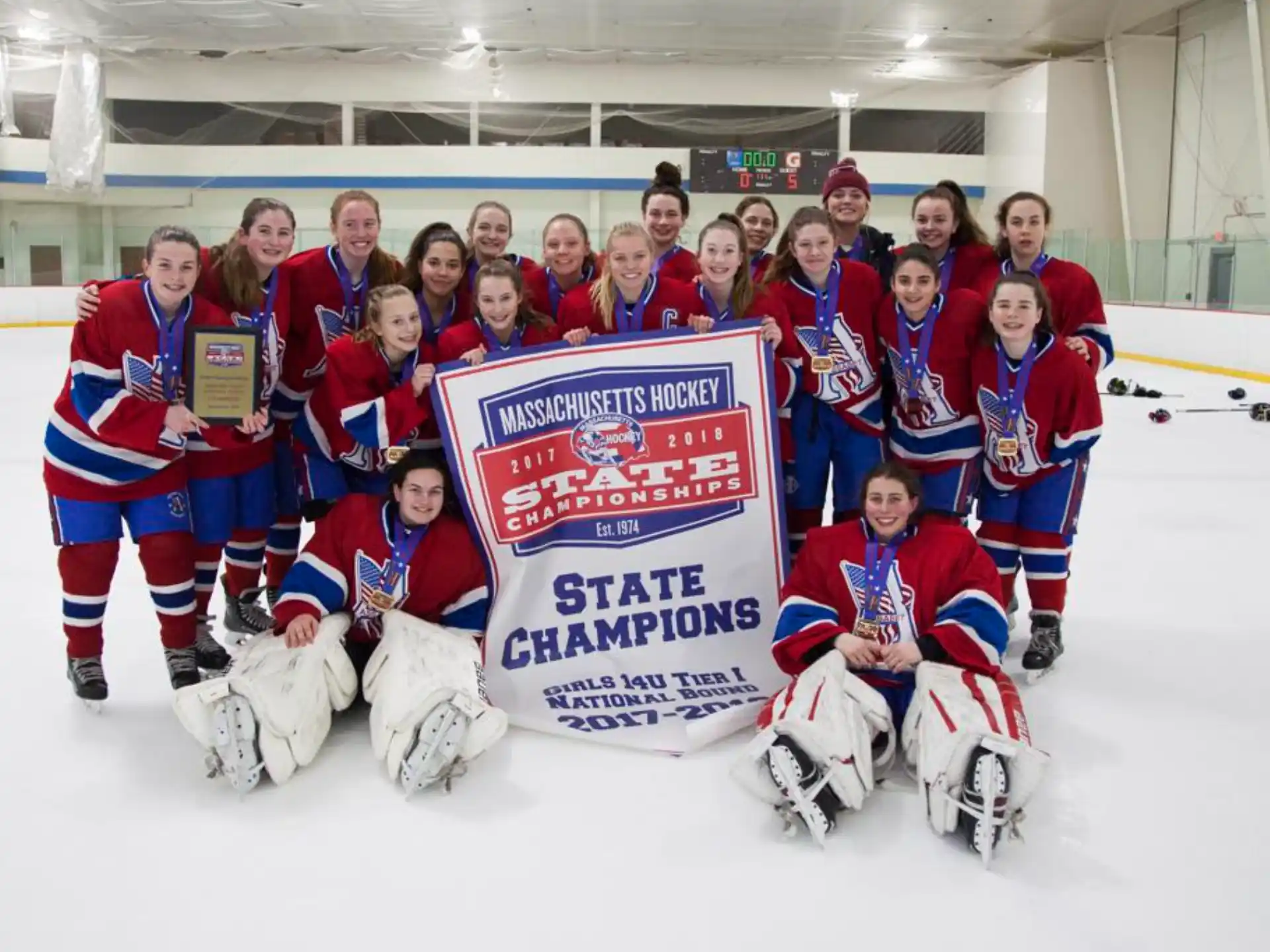 a group of people in hockey uniforms holding a sign