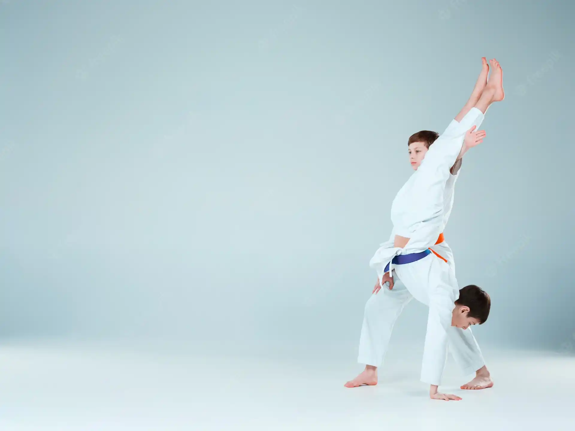 a man and a woman in karate uniforms