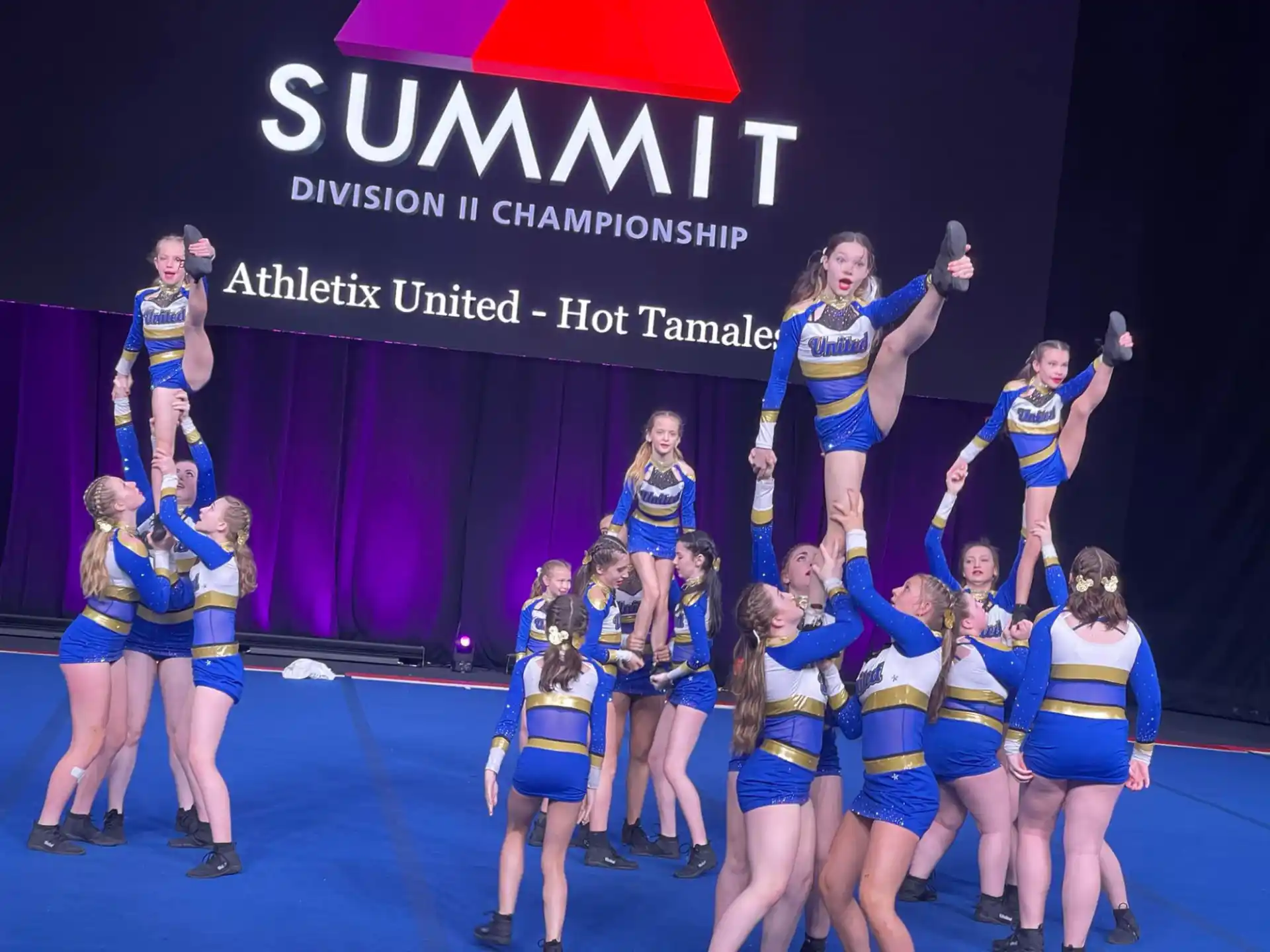 a group of cheerleaders posing for a photo
