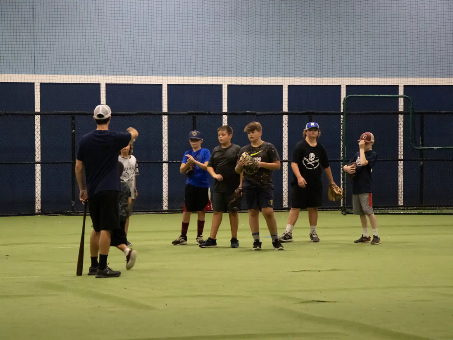 a group of people standing on a tennis court